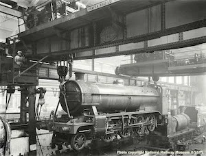 Riveted EOT crane lifting locomotive