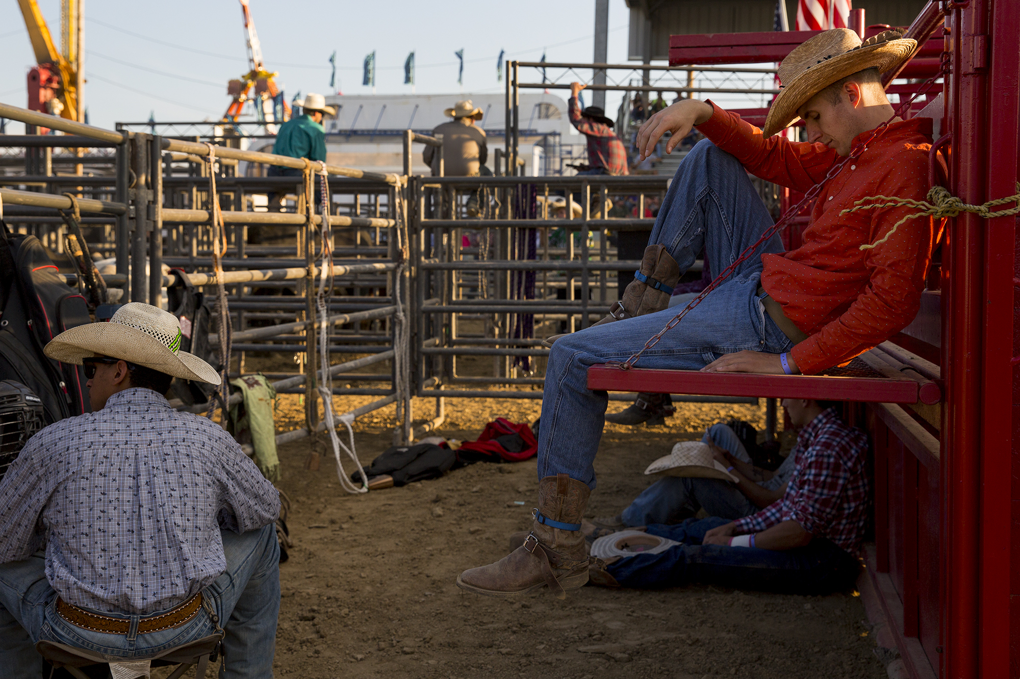  Professional bull rider Jake Schreiber (right) of Crystal Springs, Pa. takes it easy before the start of the annual Boys and Bulls Rodeo at the Fayette County Fairgrounds on August 3, 2017. 