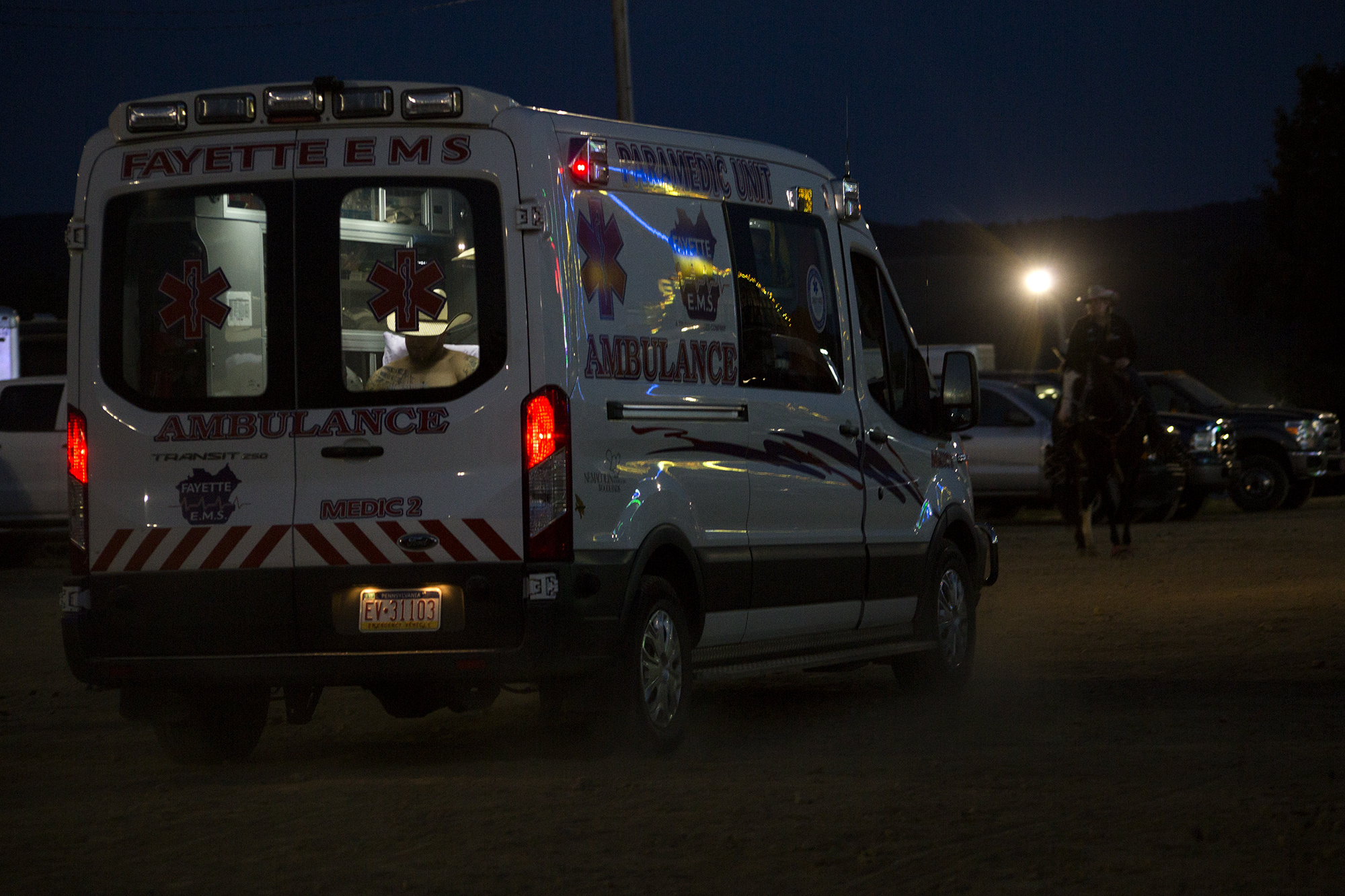  An injured participant in the Boys and Bulls Rodeo rides away in an ambulance at the Fayette County Fair on August 3, 2017. 