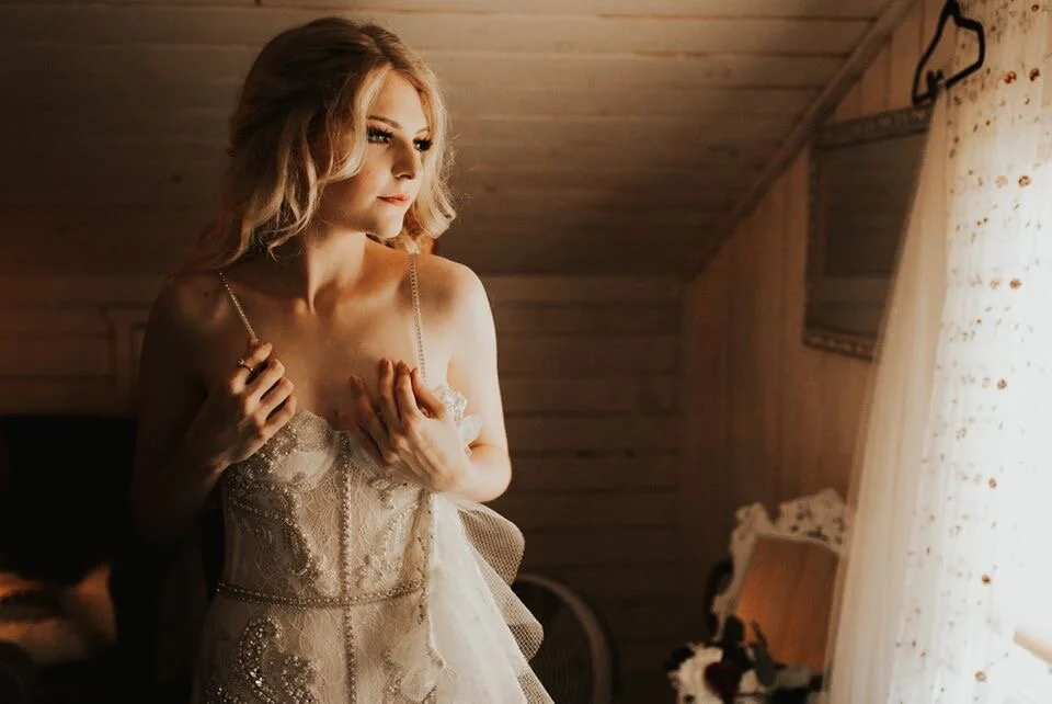 Bride getting dressed  in vintage lace handmade wedding dress
