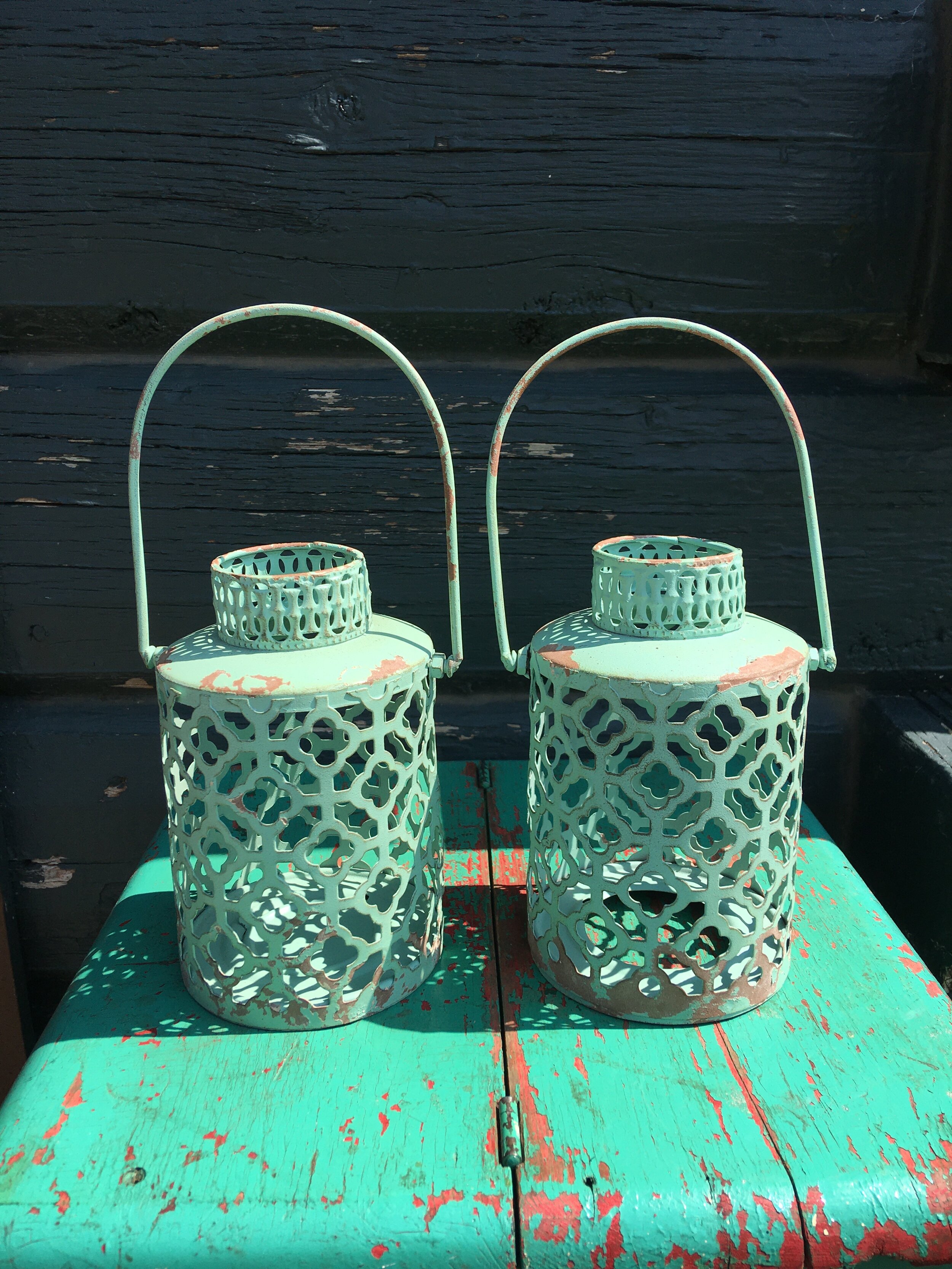 Green metal scroll lanterns pair