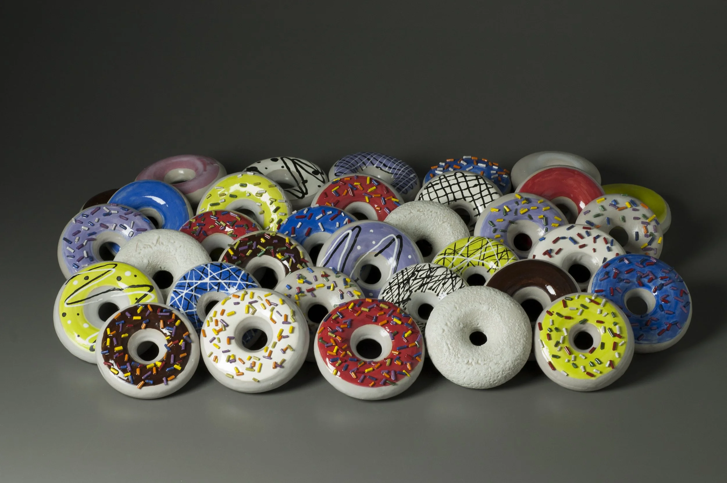     Intermediate Low Fire,  Throwing Multiples   —  Doughnuts&nbsp;       Earthenware. 5 "  x 34" x 20", 2018&nbsp;     