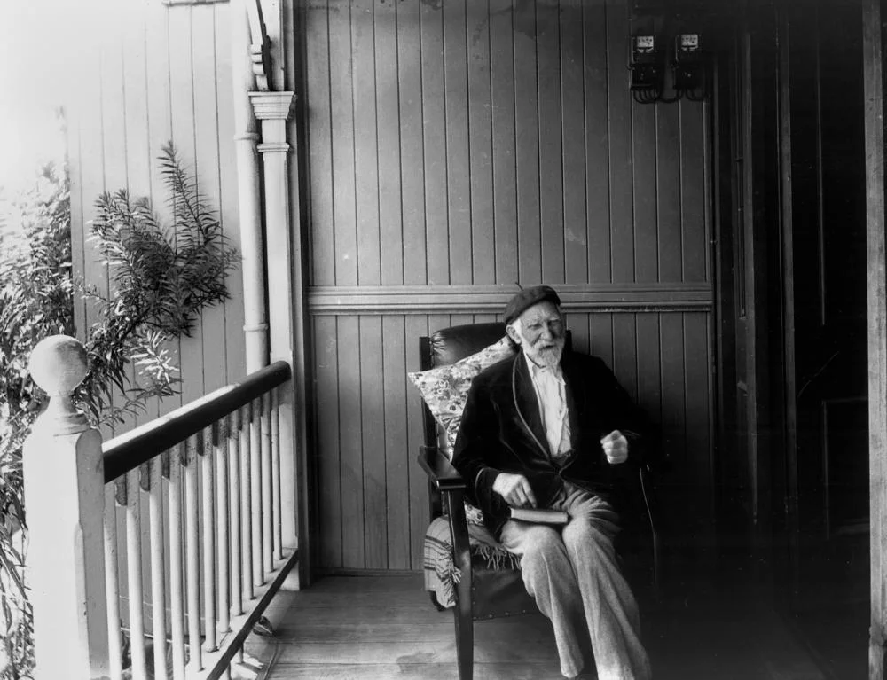 Photographer Thomas Mathewson sitting on a verandah.jpeg
