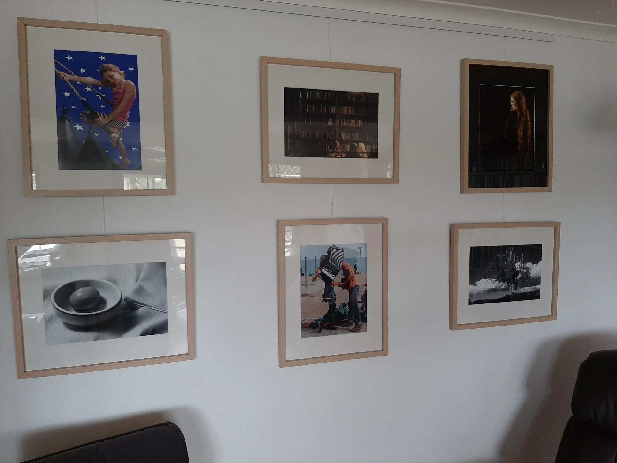 Swapsies! Phone photo of David Bulock’s home gallery, which features his own images and prints by other makers.