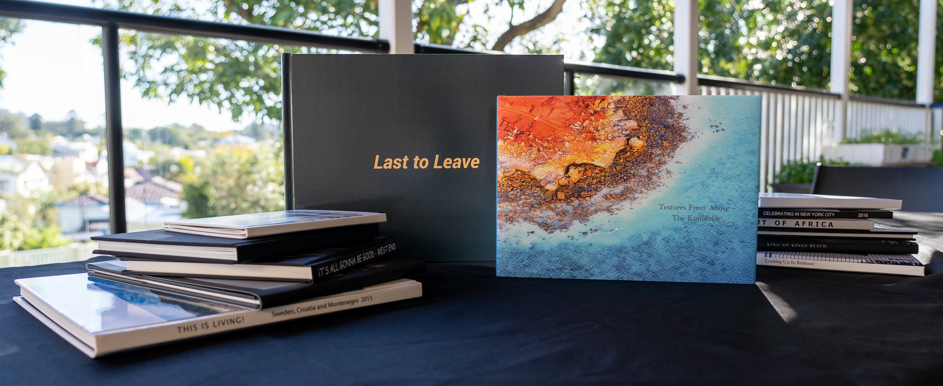 Last to Leave (left) and Textures from Above - The Kimberley (right) with the QCG 2022 photo book competition entries.jpg