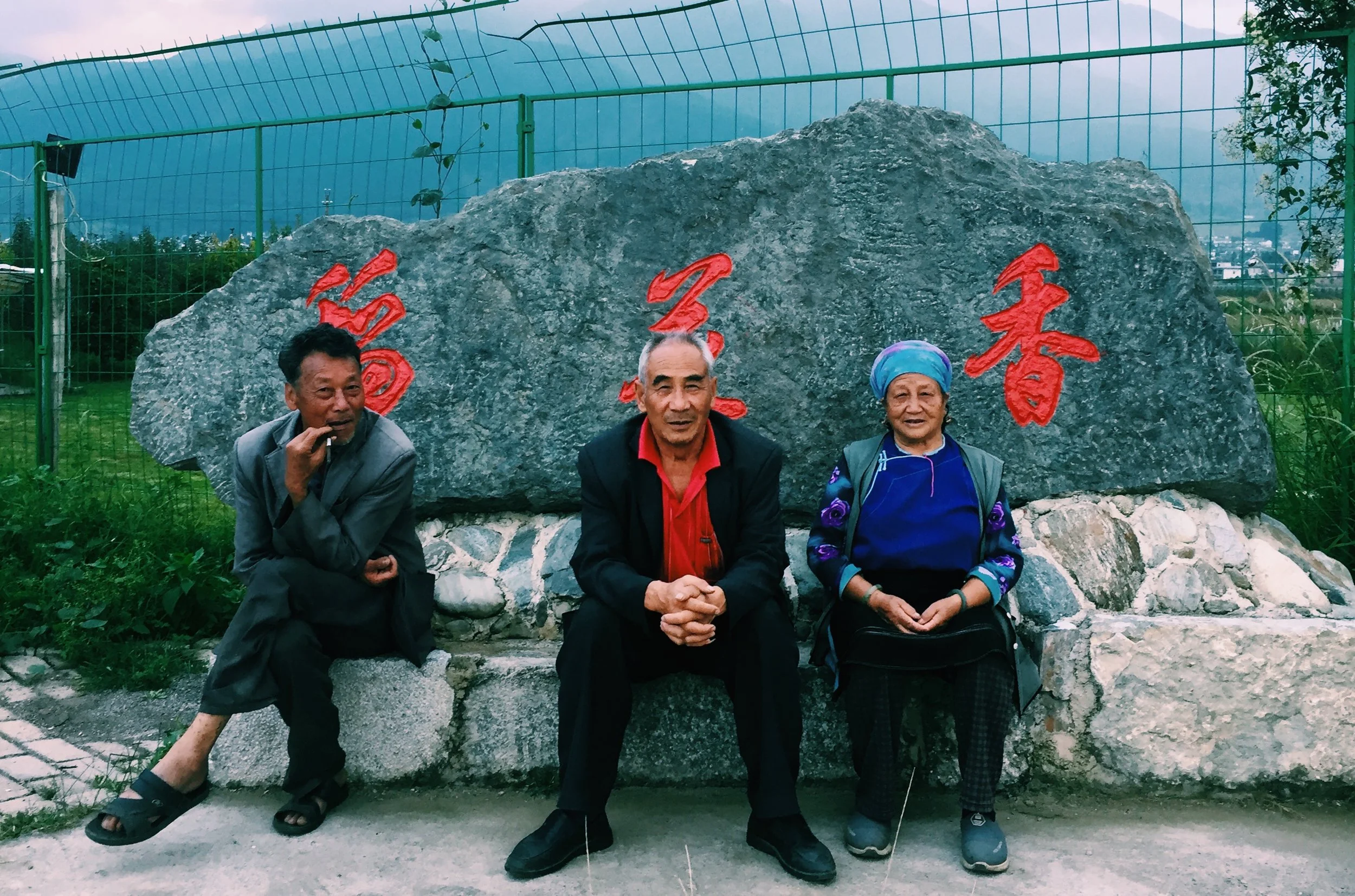 three sitting by a rock.jpg