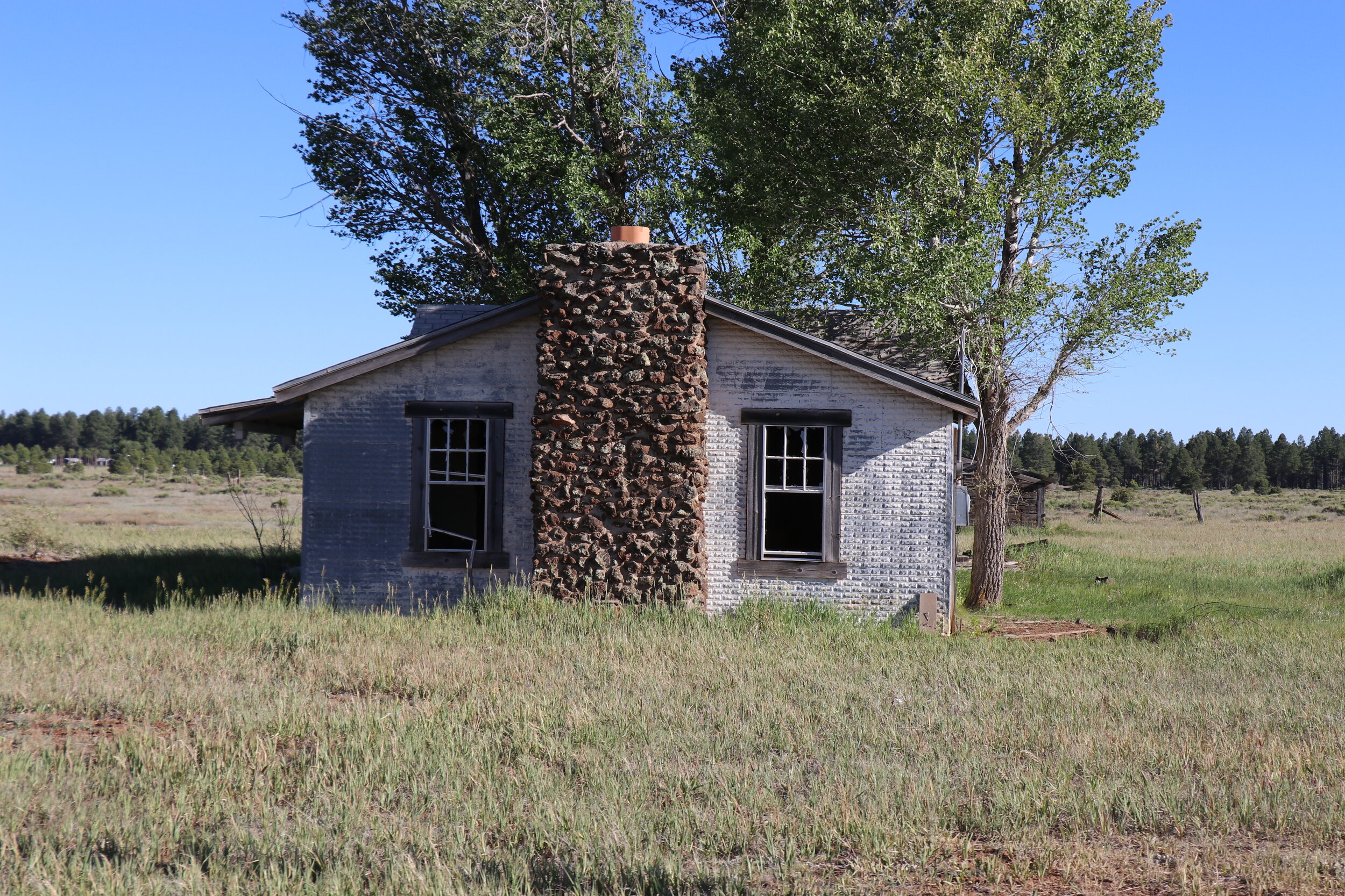 Numerous structures dot the road through the prairie.