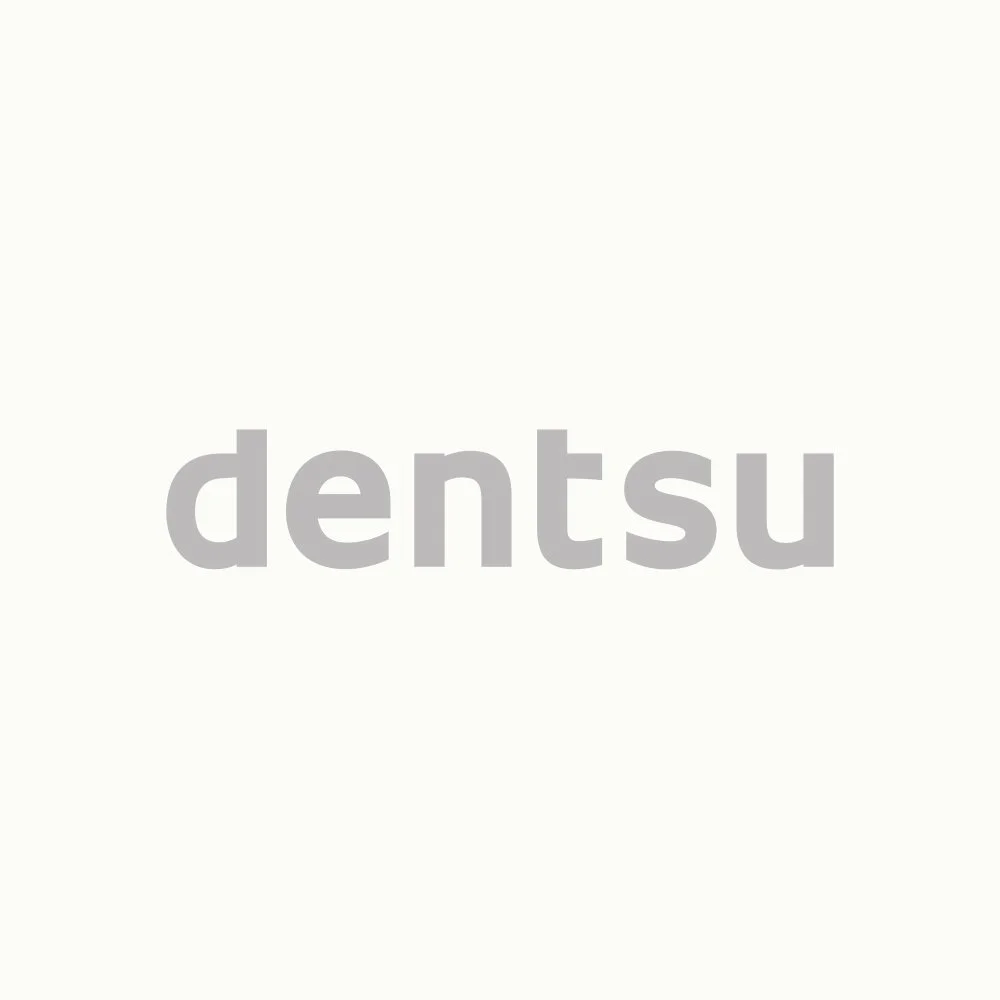 Gray text 'dentsu' centered on a white background.