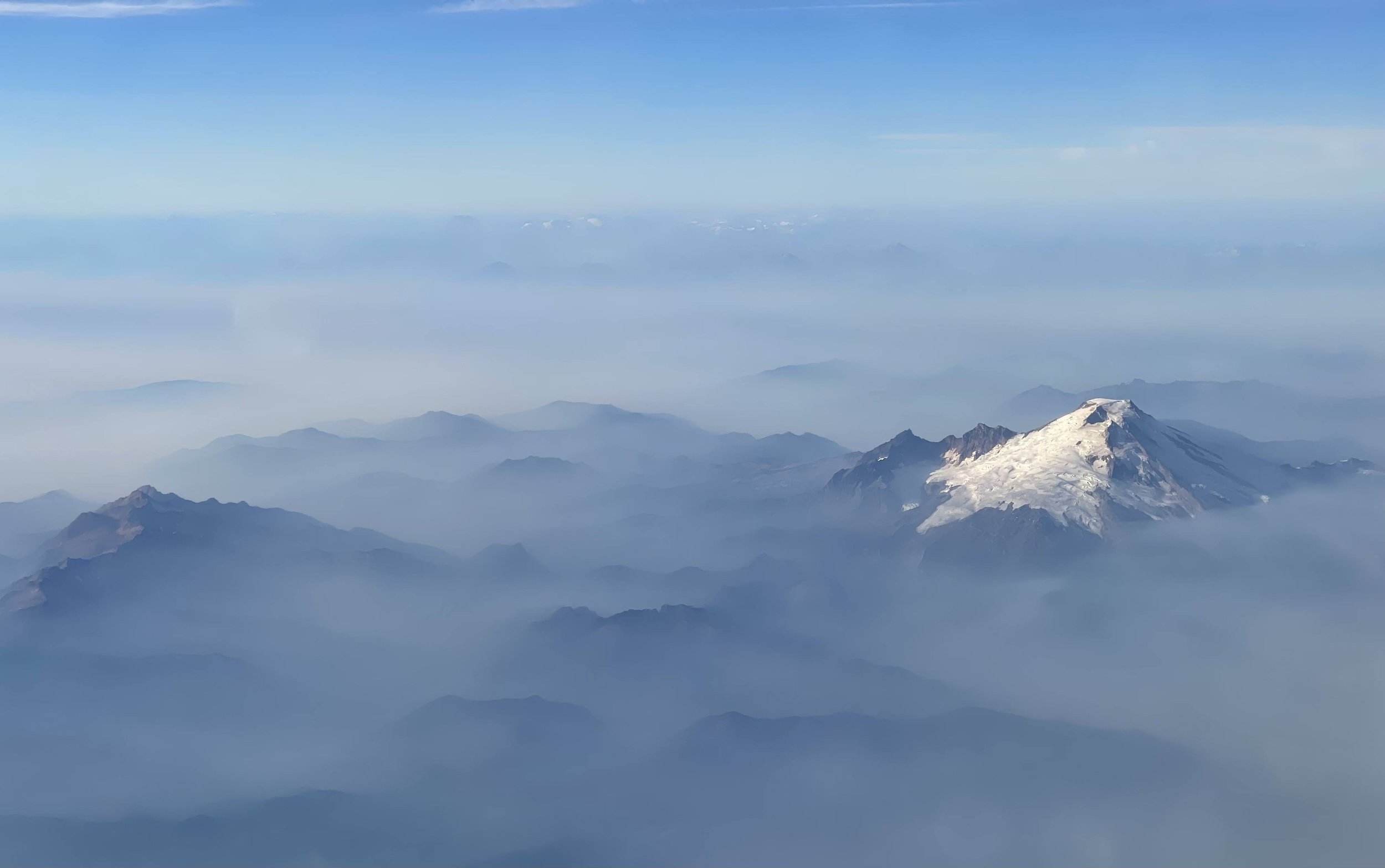 snow-capped mountain in the clouds.jpeg