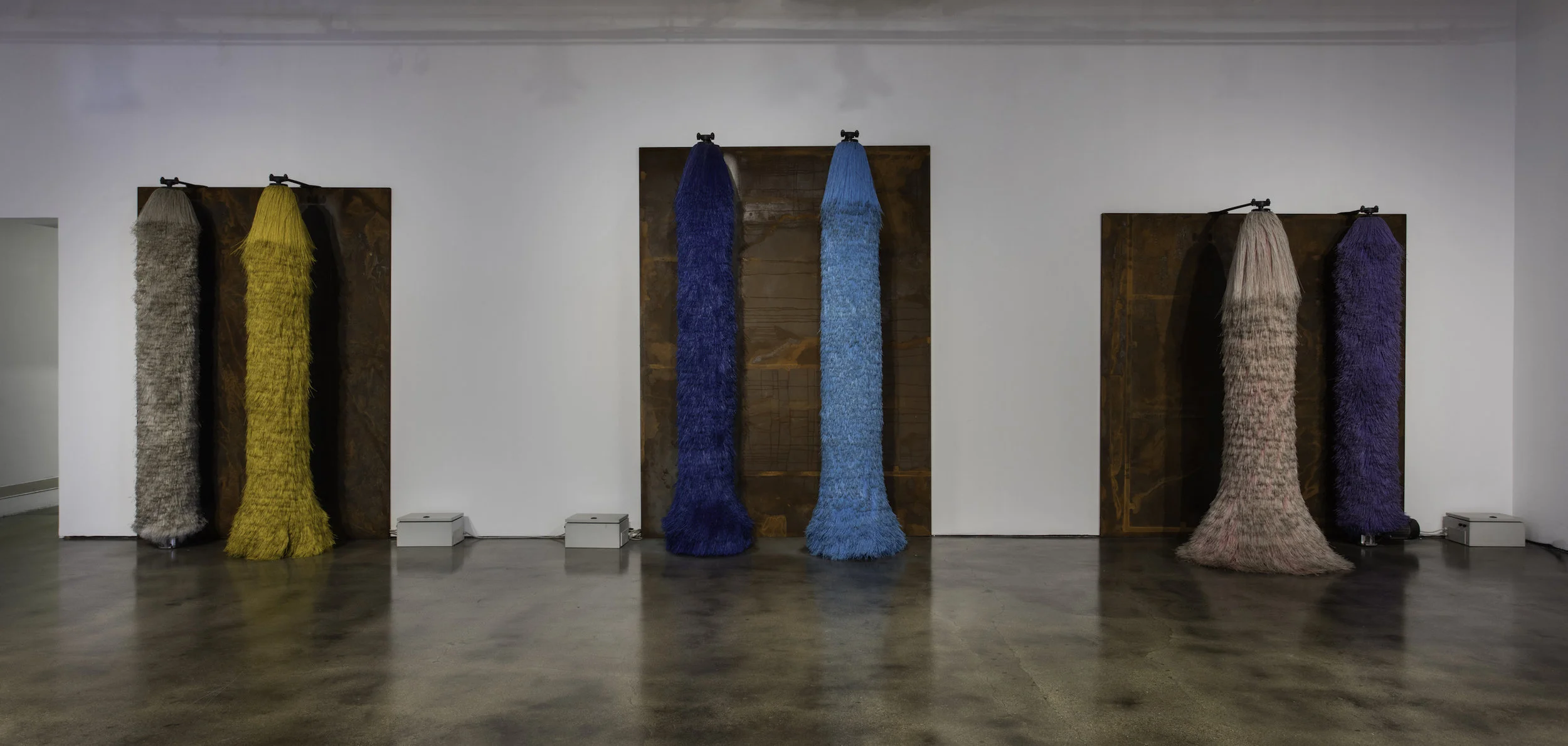 Lara Favaretto, Coppie Semplici / Simple Couples , 2009, Car wash brushes, iron slabs, motors, electrical boxes, wires, site specific installation, Courtesy Museum of Contemporary Art Santa Barbara. Photo: Brian Forrest