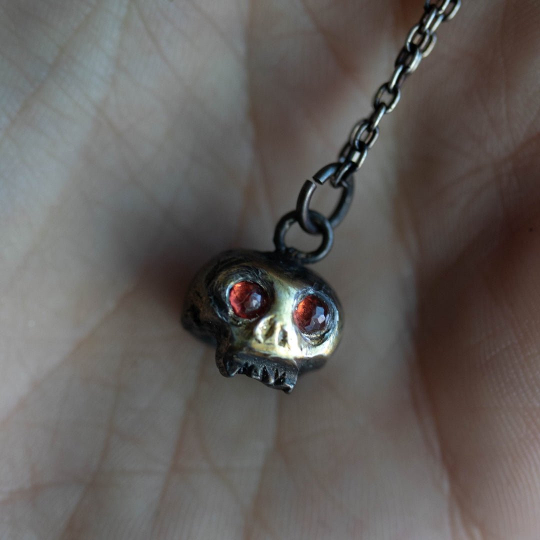 skull-charm-with-garnet-eyes-432660_1080x.jpg