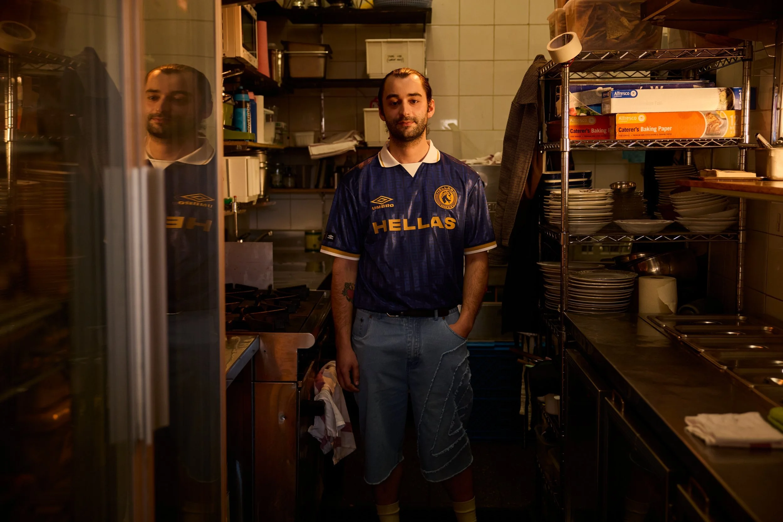 Portrait in an Umbro Hellas jersey inside a Melbourne café