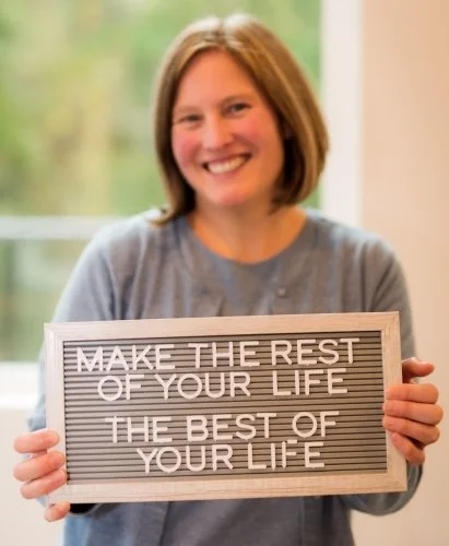Make the rest of your life the best of your life sign held by Coach Shelly Rees Randall, CDFA, CDC