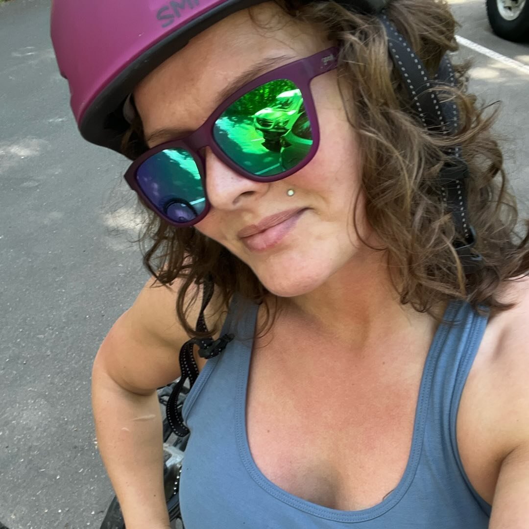 Picture of Hannah Grossman wearing a bicycle helmet and sunglasses