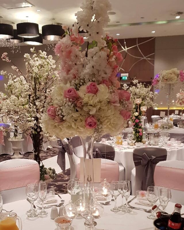 #centerpieces #weddingcenterpieces #Londonweddings #pinkandwhiteblossoms #hangingcandles #tabledecor #chairback #chaircovers #roses #hydrangea #silver @hiltonwembley