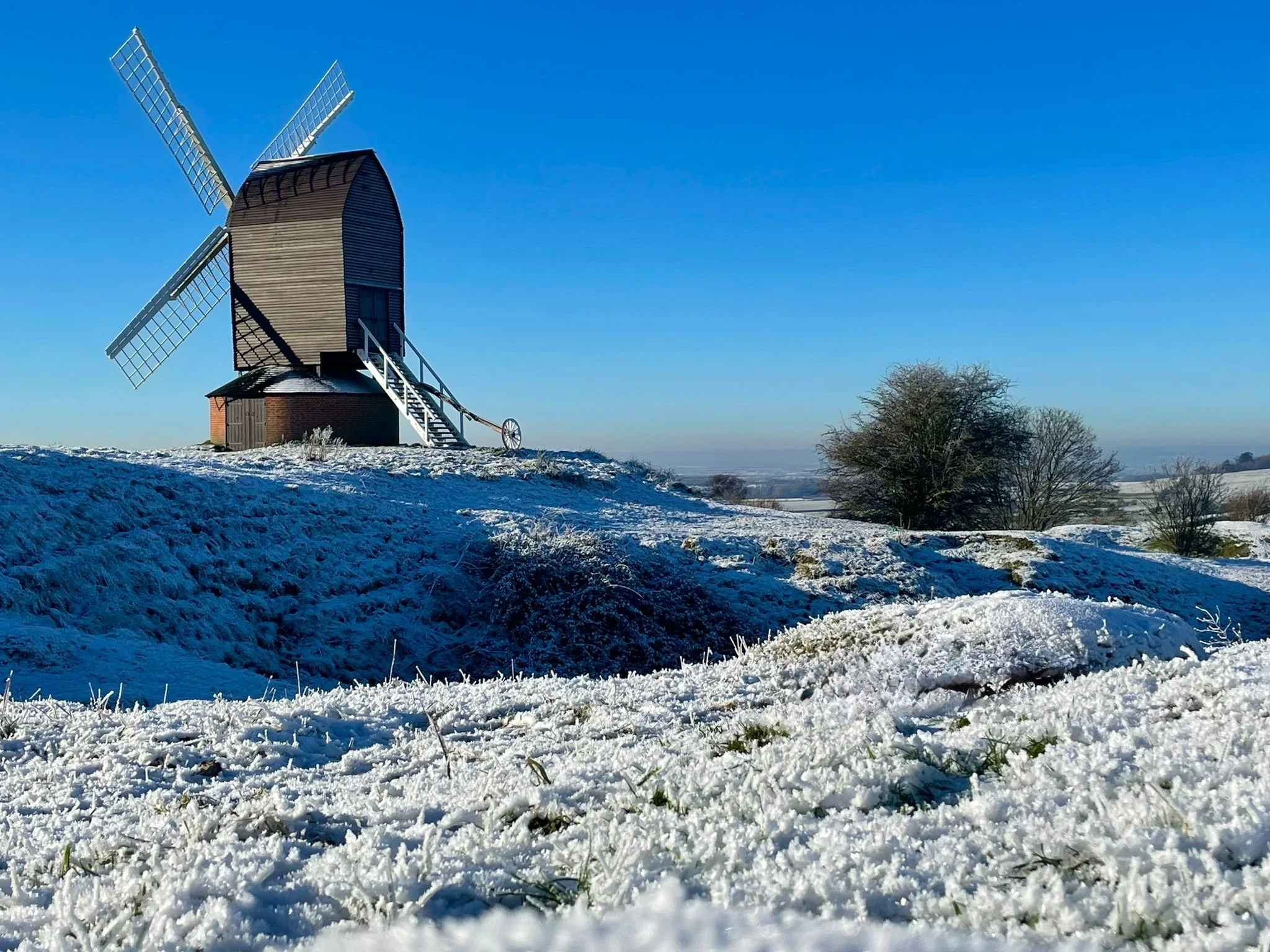 Brill windmill and surrounding Common under light cover of snow.