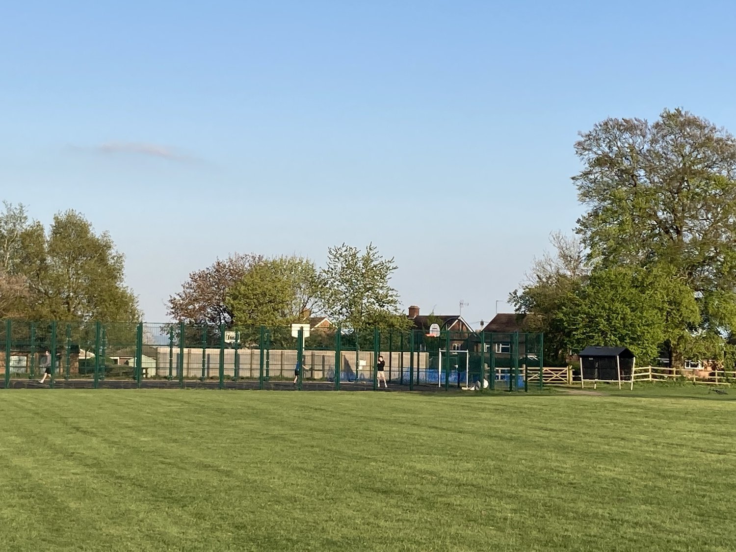 Photo of MUGA with trees behind.