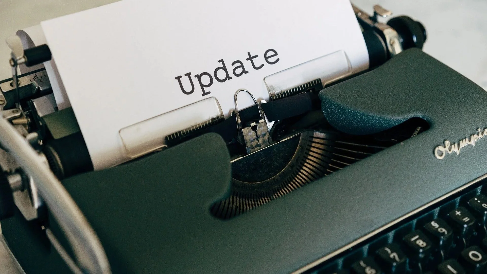 Manual typewriter with paper inserted reading 'Update'.