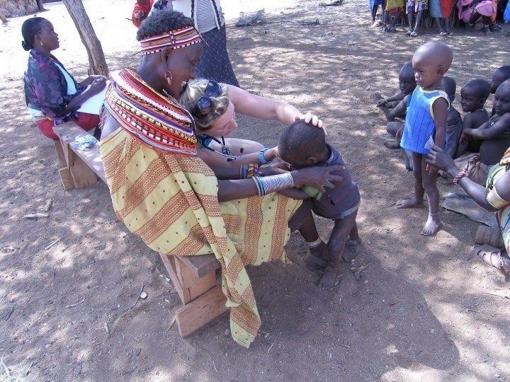  The community attending a mobile clinic for public health education, primary health care and child vaccinations 