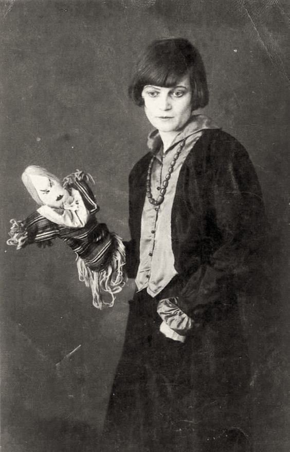 Swiss Dadaist Emmy Hennings with one of her dolls. 1917.