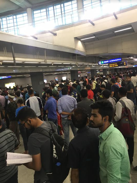 At a metro station in Delhi. Whoever managed to get these lines organized deserves a nobel peace price.