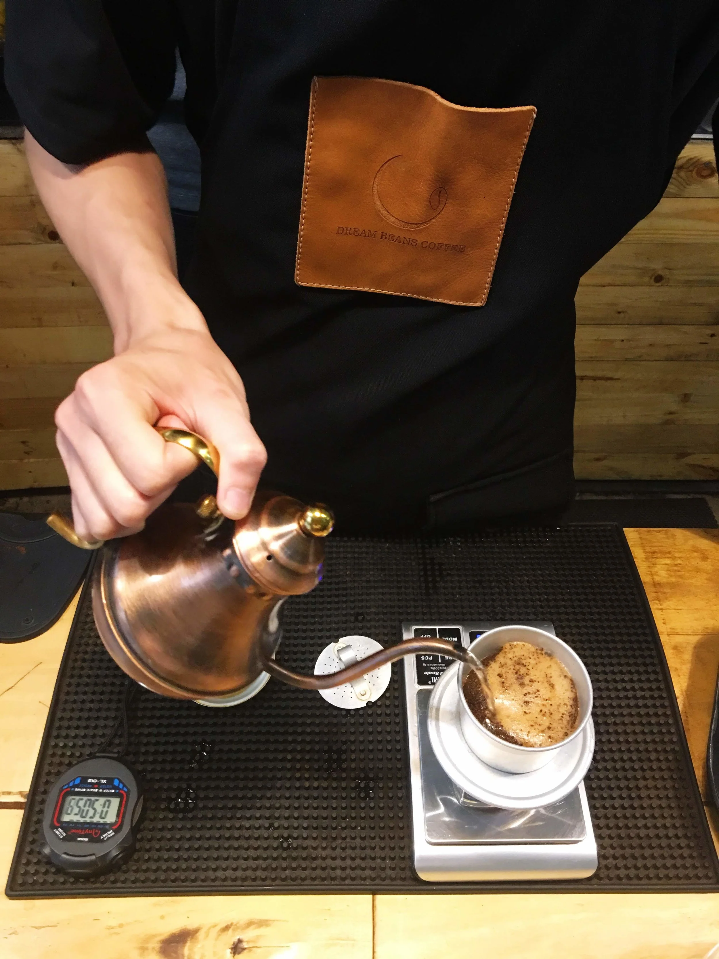 Preparing phin style coffee, traditional Vietnamese black coffee.