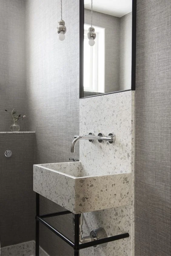Guest Bathroom with Mirror and Basin in Terrazzo by Liljencrantz Design | Structure Wallpaper from Elitis | Lighting by Michael Anastassiades for Svenskt Tenn