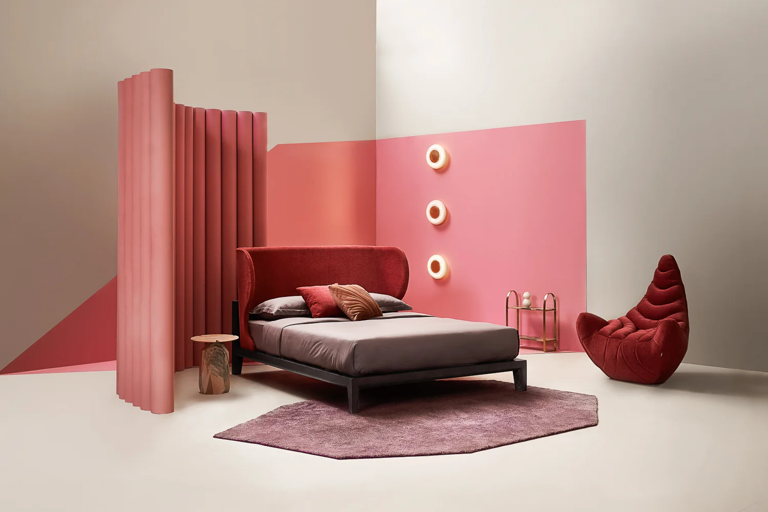 Curve Bed Stained Solid Wood & Upholstery | 12”x 78”x 36” Croissant Arm Chair Upholstery & Hand Moulded Fiber | 41”x 35”x 38” Cosmos Faceted Side Table Hand Carved Marble | 17”x 9”x 8” Pebble Sconces Hand Carved Marble & Hammered Copper | Diameter 12”x 5” Jewel Rug Tufted Polyester Cut Pile | 8”x 5” Mudd Quilted Cushion Quilted Cotton Velvet | 18”x 18” Eloise Side Table Passivated Metal & Marble | 17.75”x 20”x 7.5”