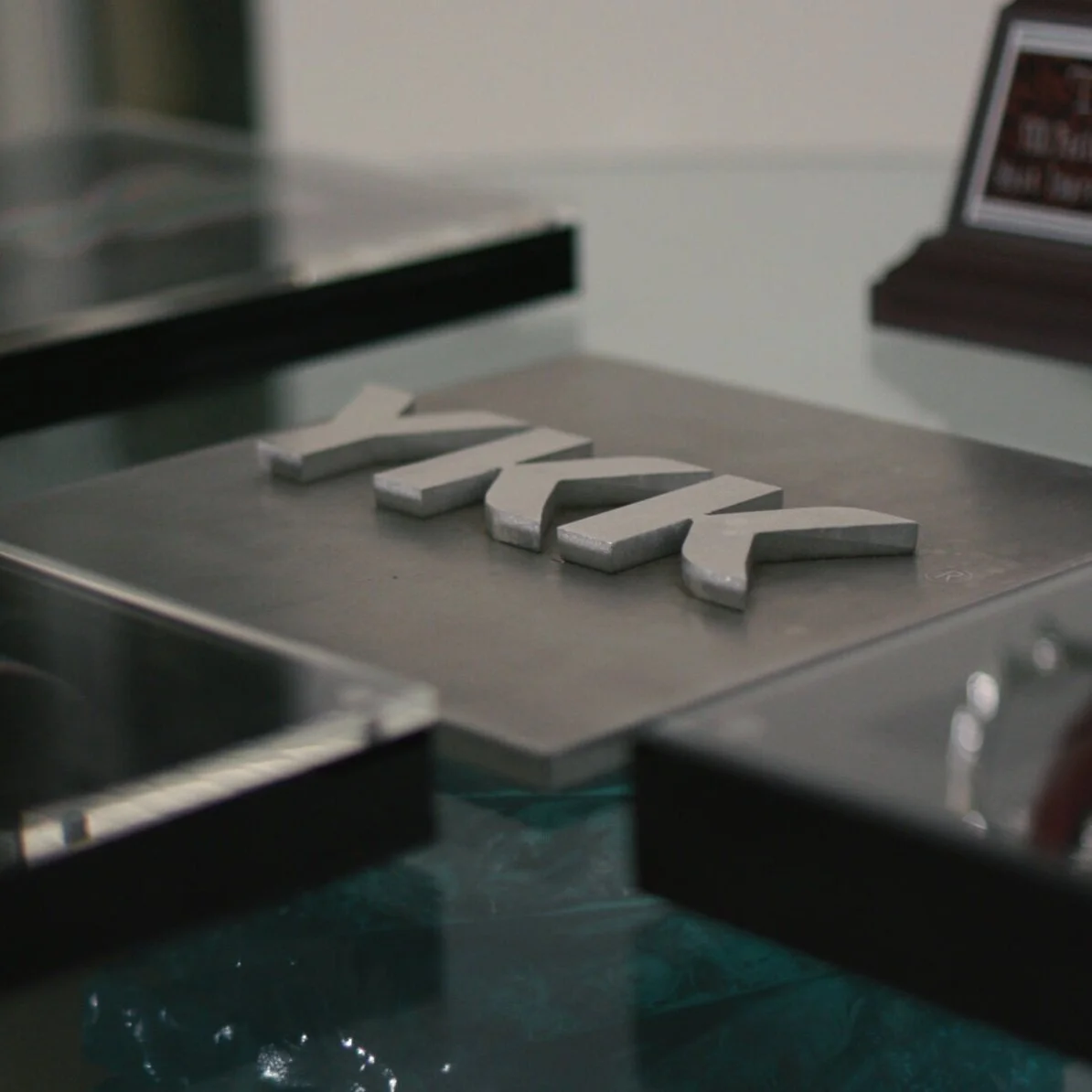 Close-up of YKK zipper components on an industrial production line.