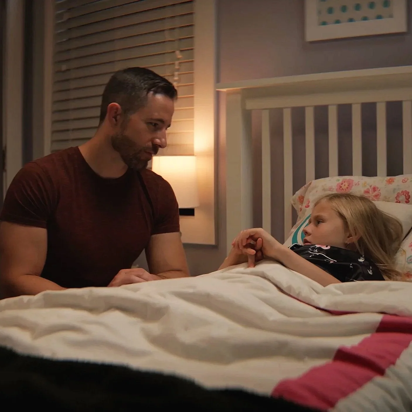 Father comforting a child at bedtime in Northwest Exterminating’s “Little Monsters” commercial.