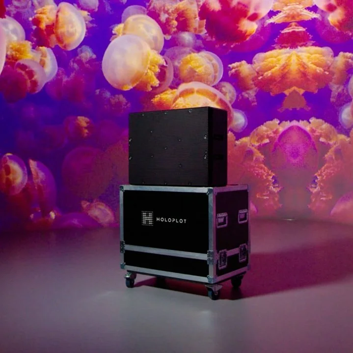 Holoplot speaker system displayed in a studio environment with colorful lighting.