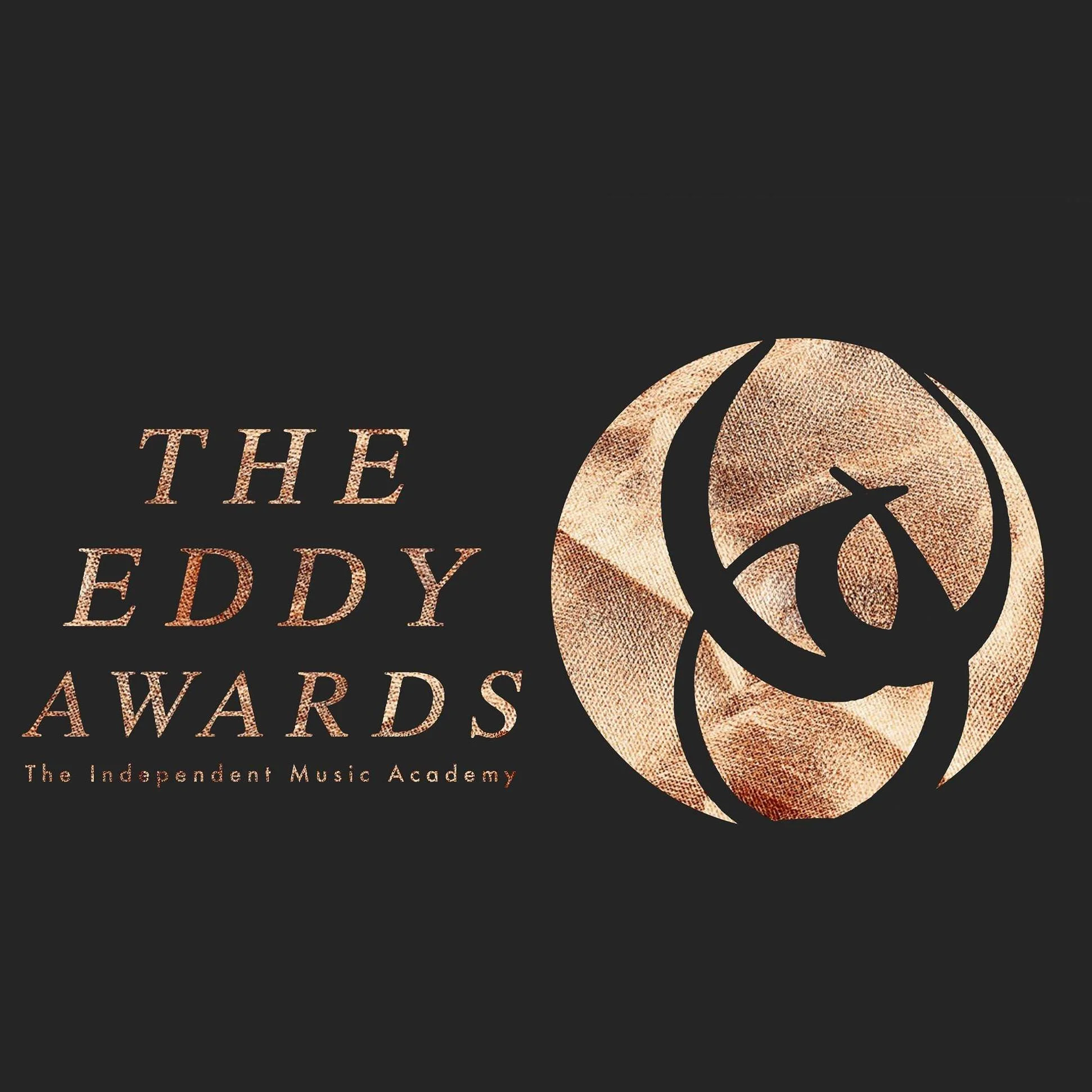 Design for The Eddy Awards by The Independent Music Academy, featuring stylized circular emblem with abstract shapes and textured background in shades of brown and beige on black background.