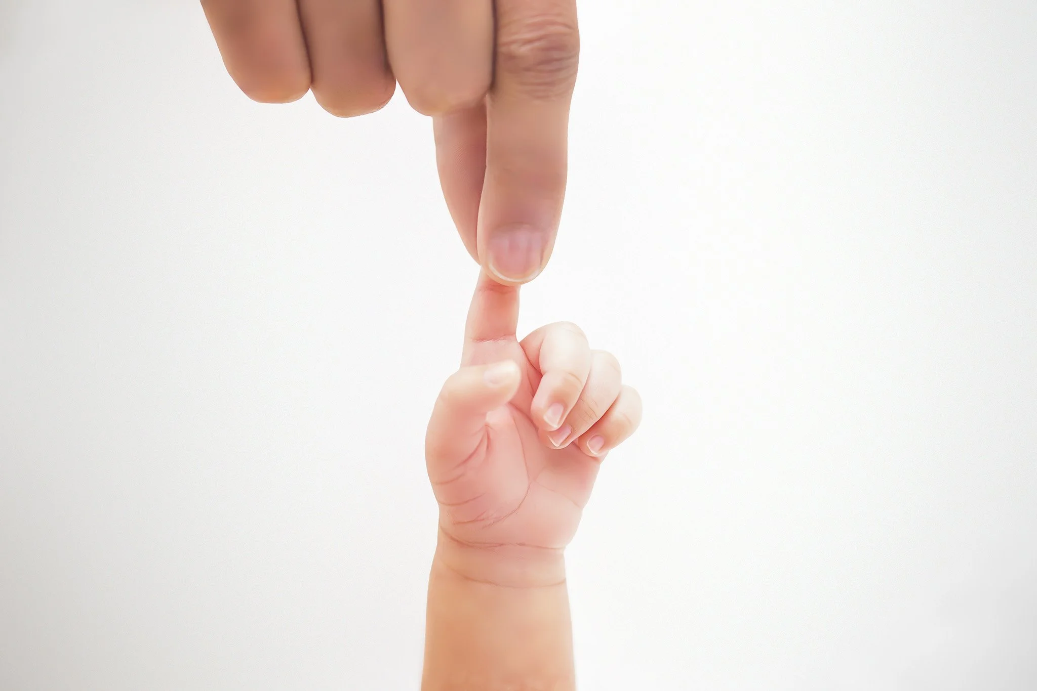 parents hands holding babys finger.jpg