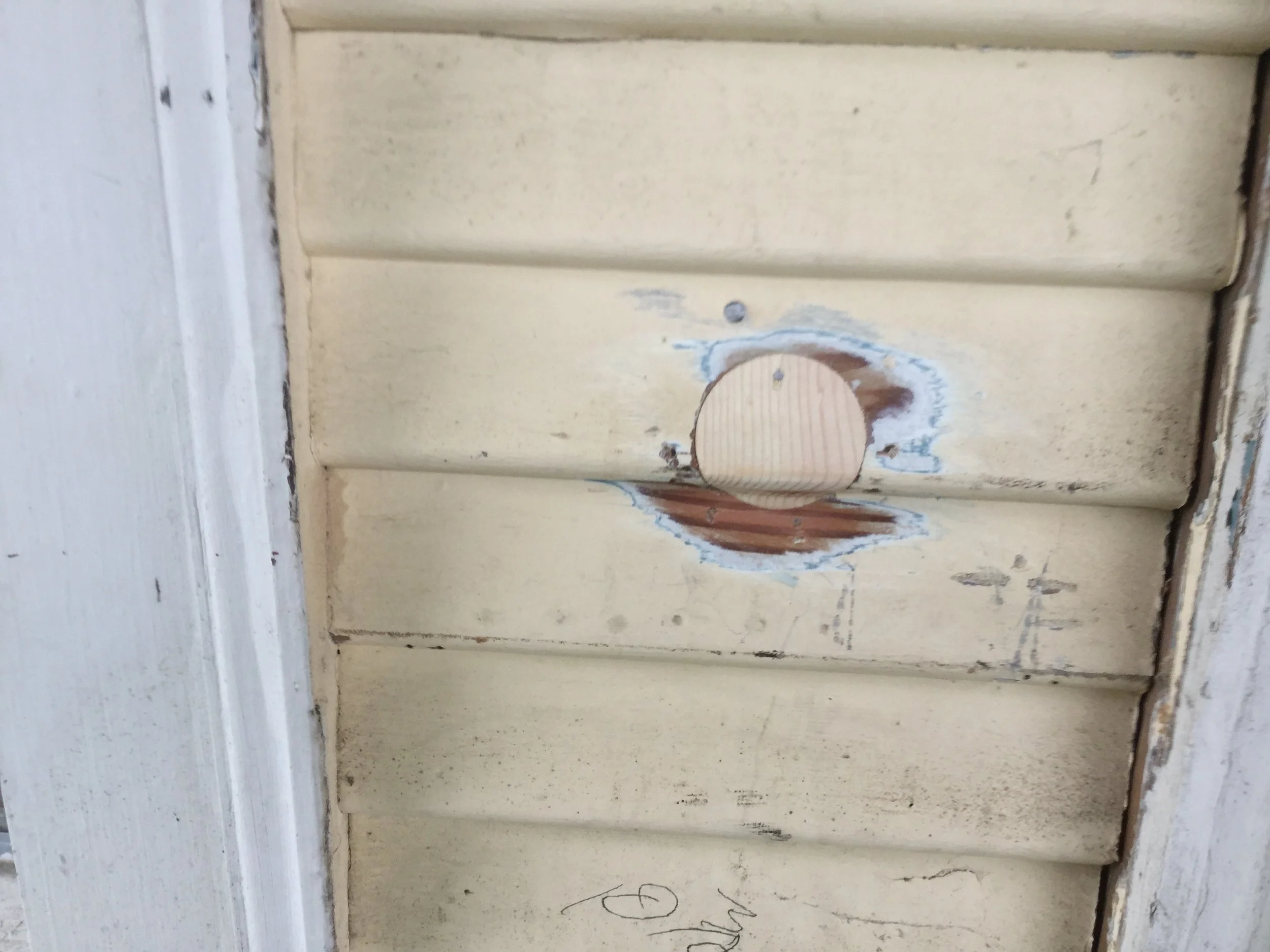 Cedar wood plug for existing insulation hole in siding.