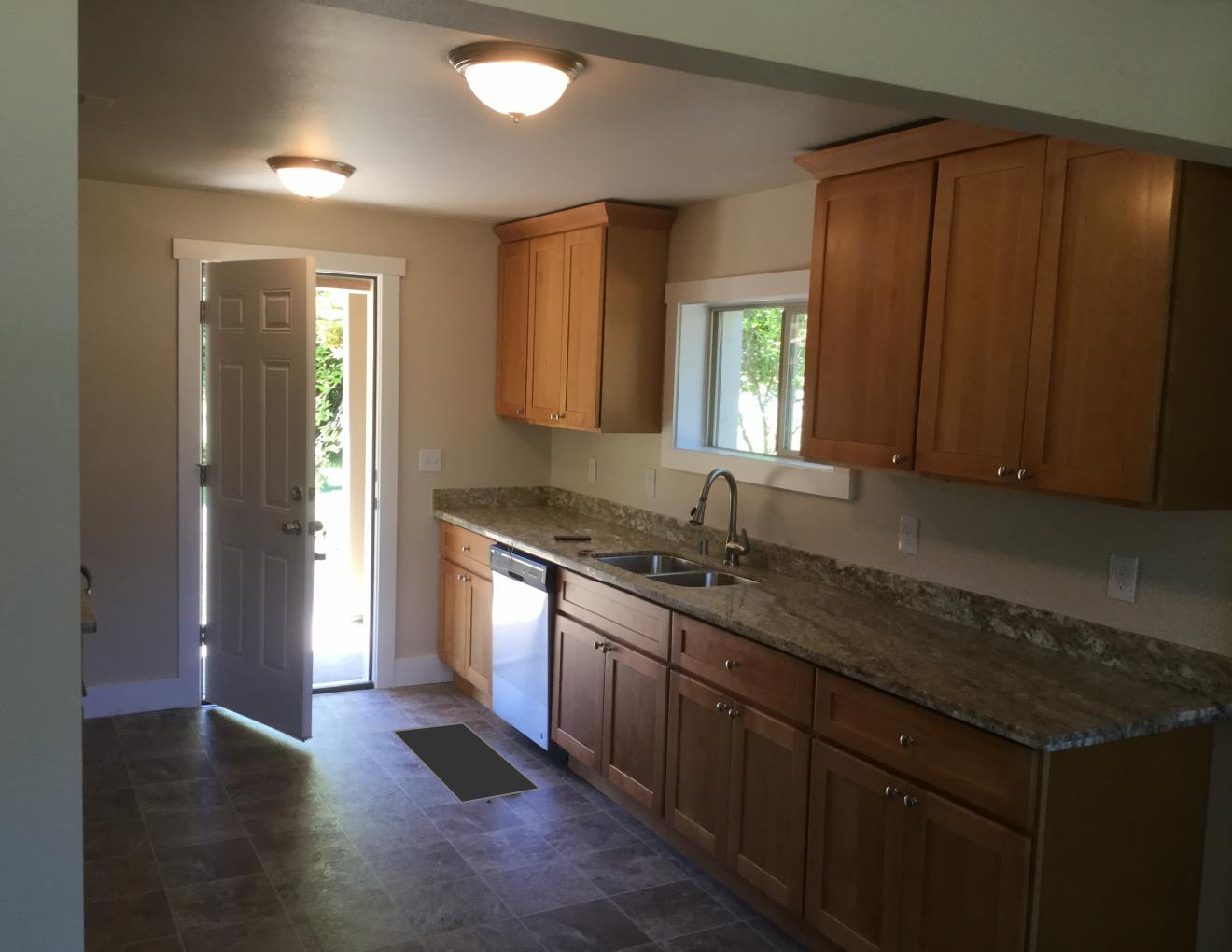 Solid cherry wood cabinets with granite countertop &amp; stainless steel under mount sink.