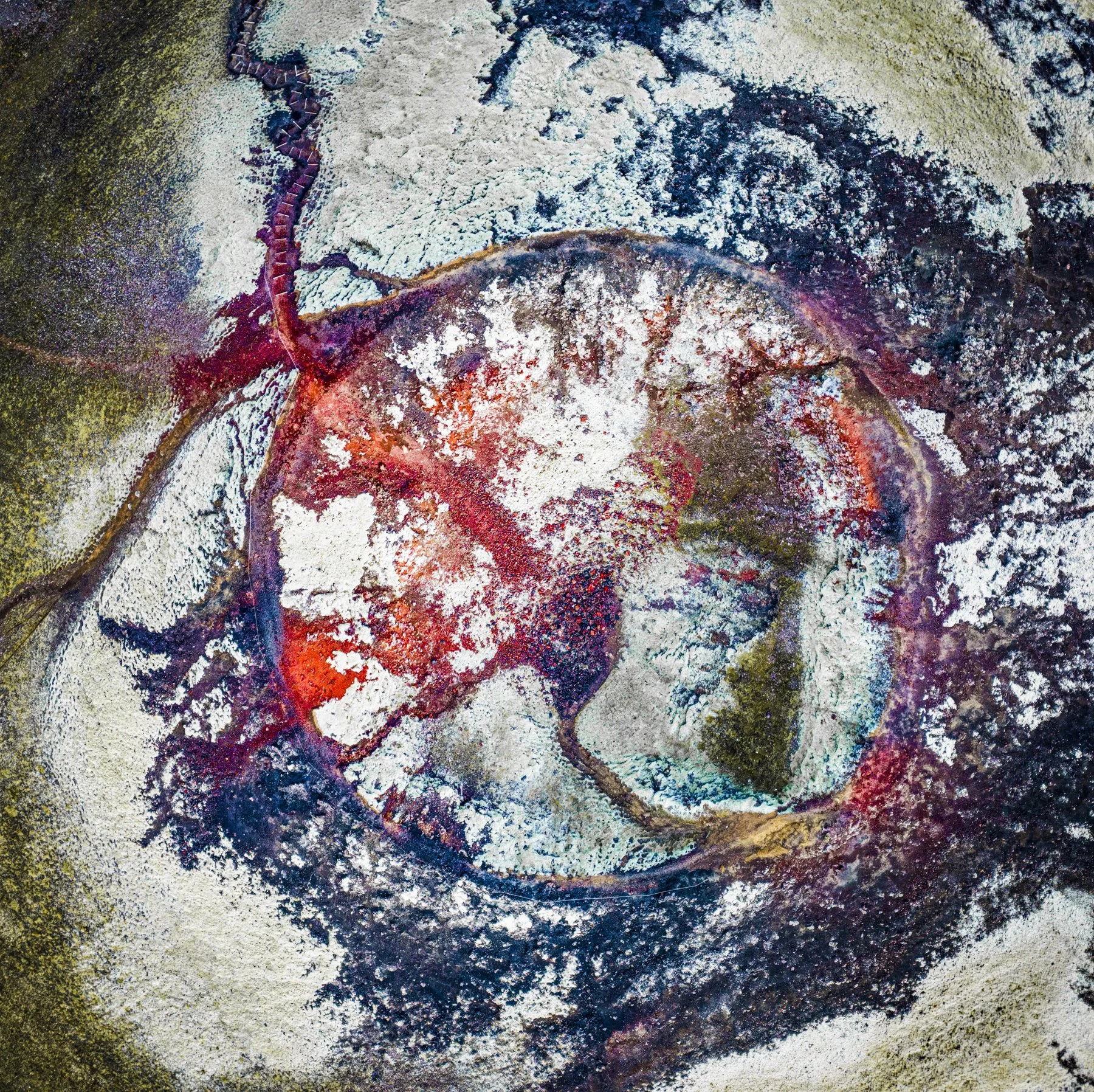 Eye. Abstract landscape photograph of volcanic crater combining iron oxide red, green and earth tones, with natural forms creating an eye like composition.