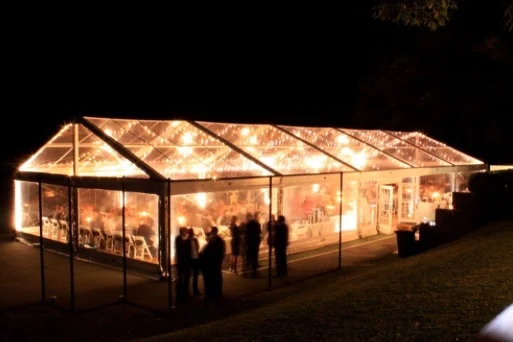 Clear Marquees with festoon lighting creates a stunning evening event space.