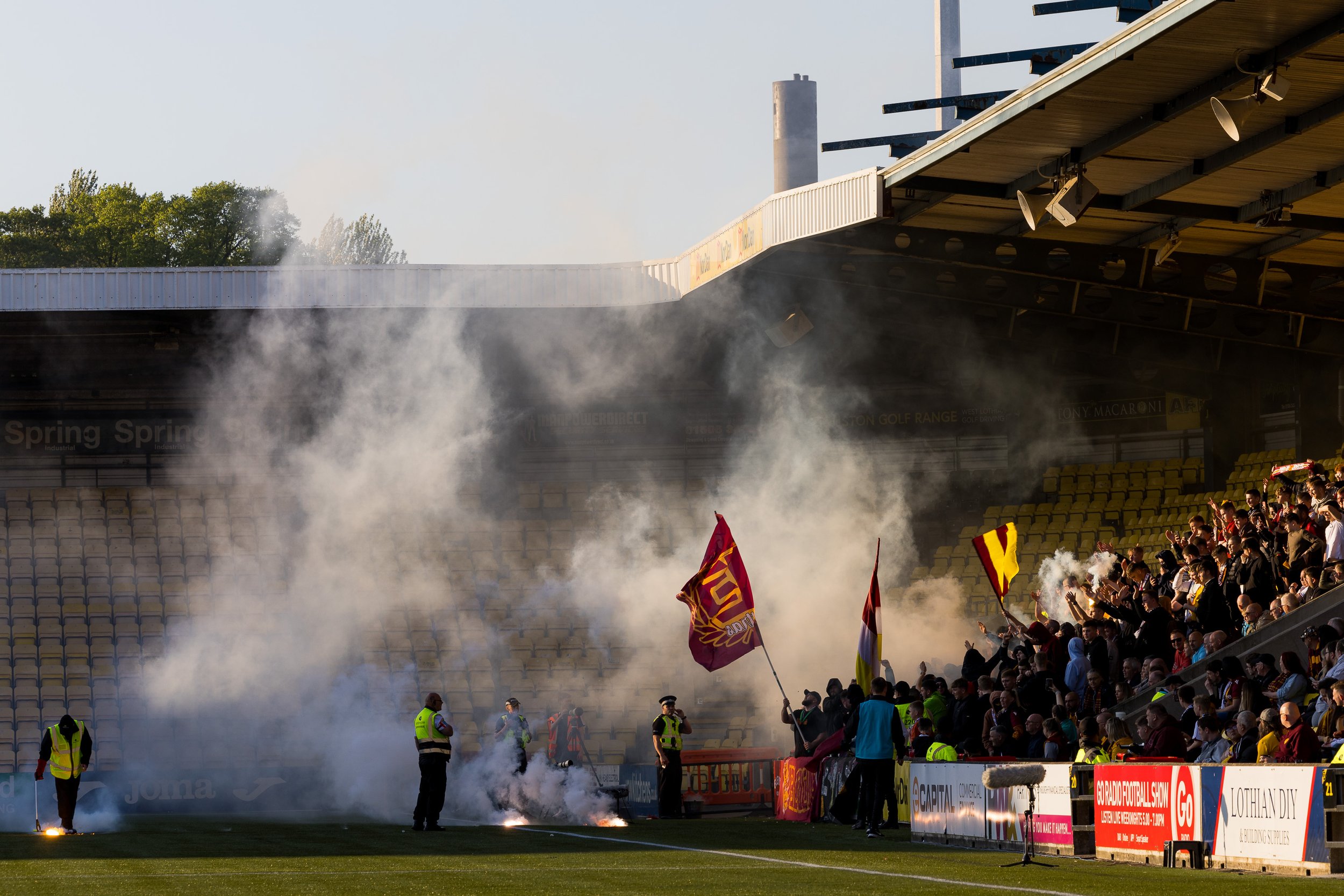  Motherwell fans throw flares on the pitch at The Tony Macaroni Arena 