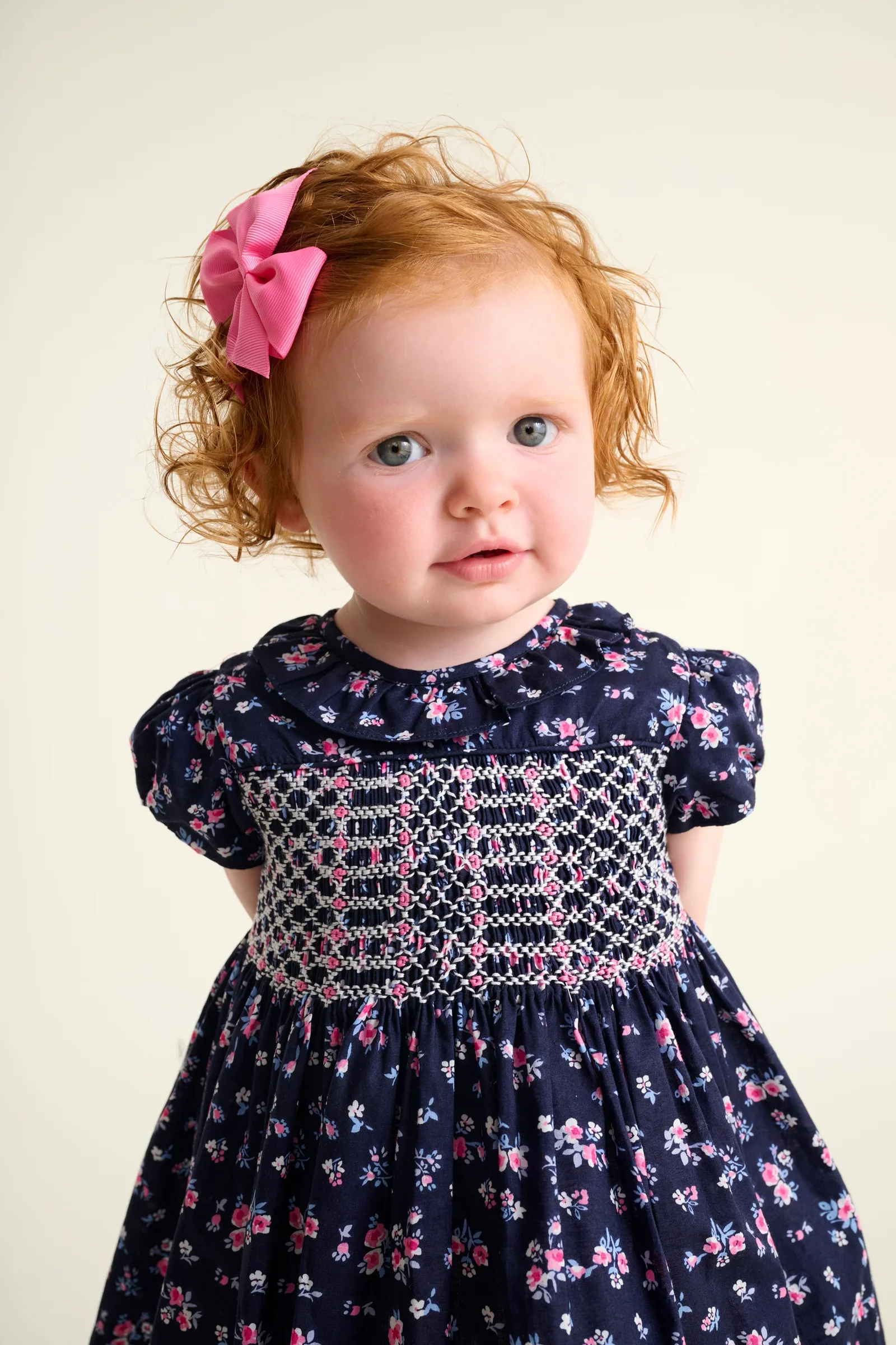 navy-baby-dress-indie-smocked-closeup.webp