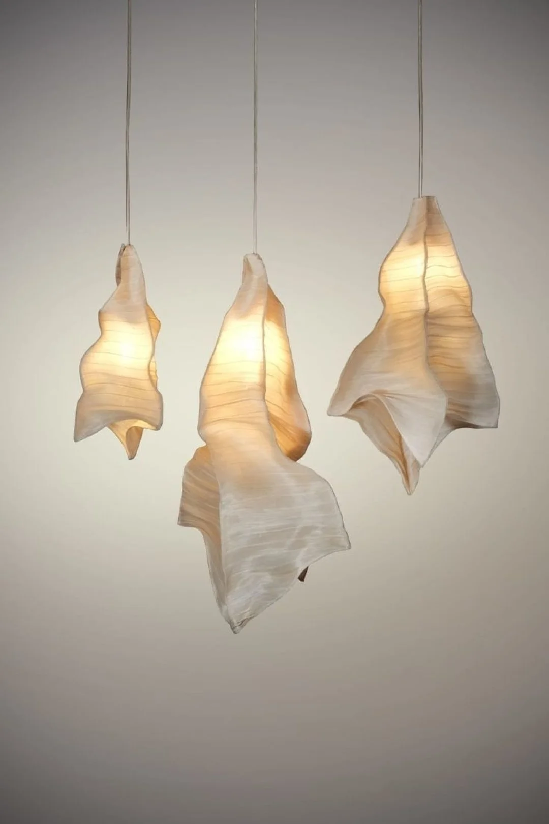 #MaterialMonday These sculptural pendants from Wescover blur the line between lighting and art. Their organic, hand-formed silhouettes and softly diffused glow bring a warm, ethereal texture to any space&mdash;proof that materiality can completely tr