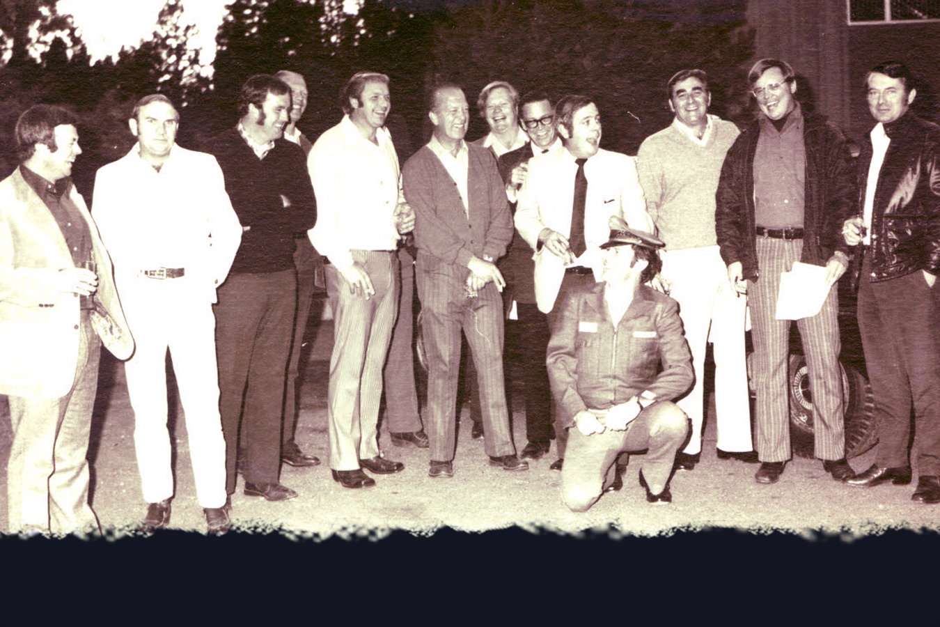After taking over for a drunken cab driver on a group visit to Las Vegas in 1980, member Curt Boulet (kneeling) receives a Checker taxi, jacket and hat as a joke from fellow Club members on his birthday.