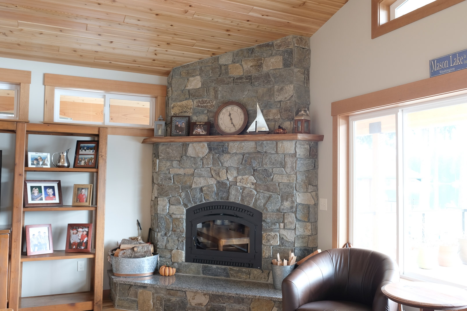   Corner Wood Burning Fireplace with Stone Face, Raised Hearth and Wood Mantle  