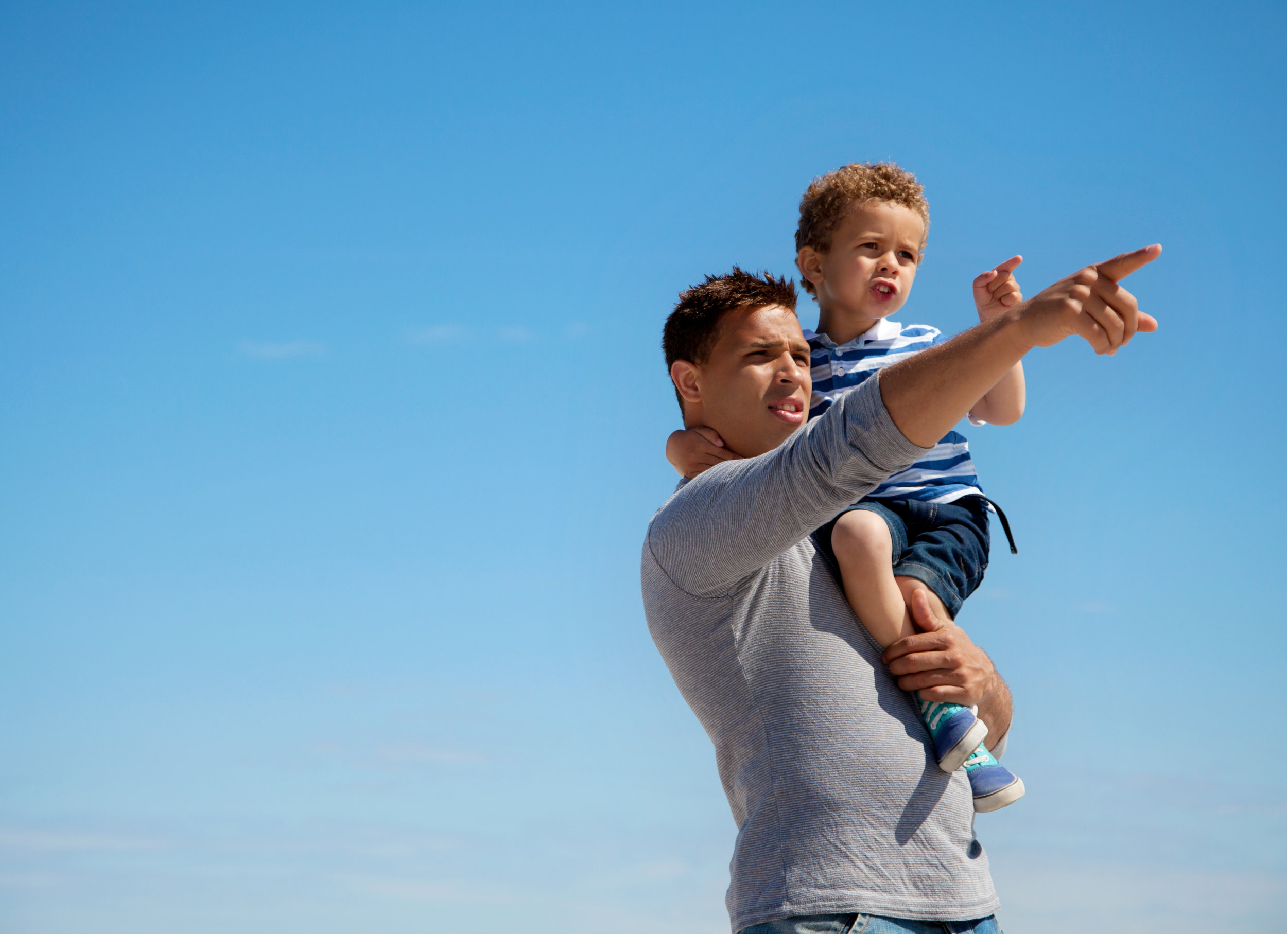 dad-pointing-something-to-his-little-son-outdoors_SpkMAr4tl.jpg