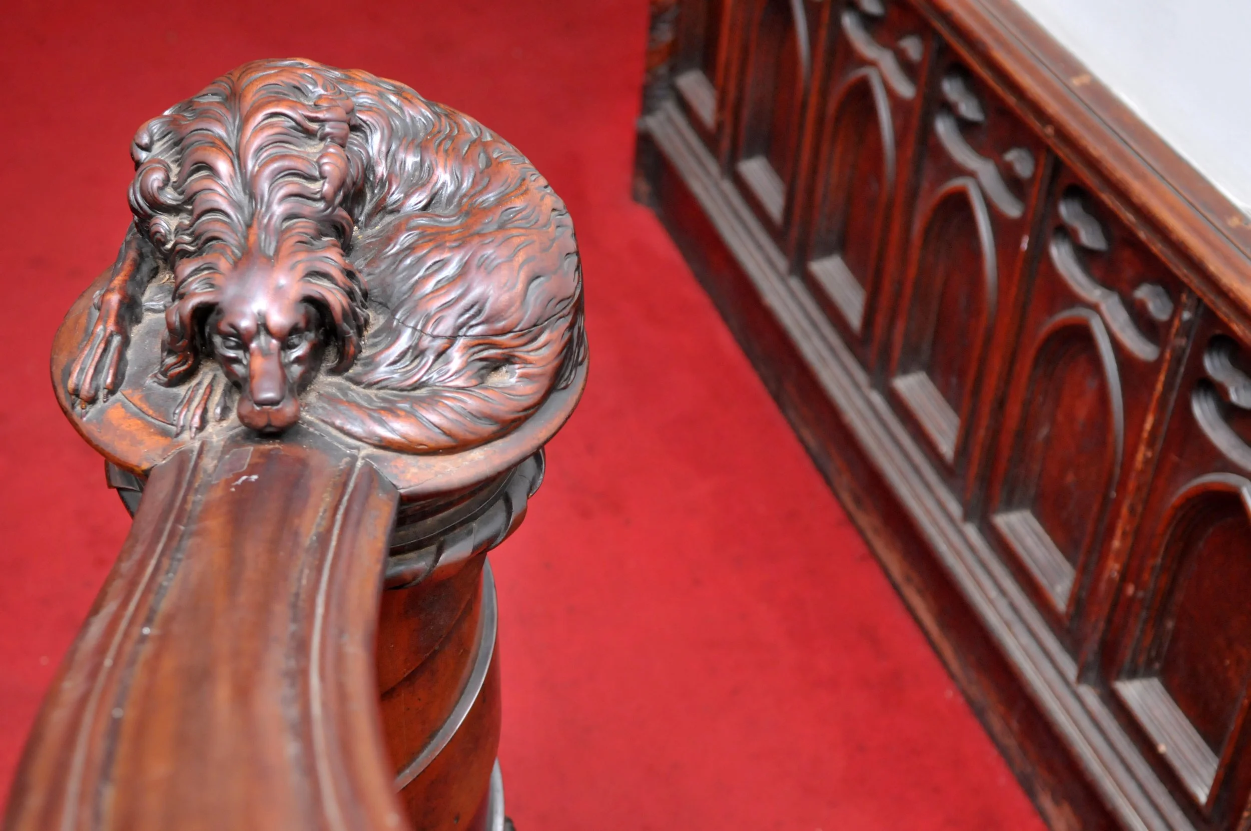 Carved dog decor on stair rail