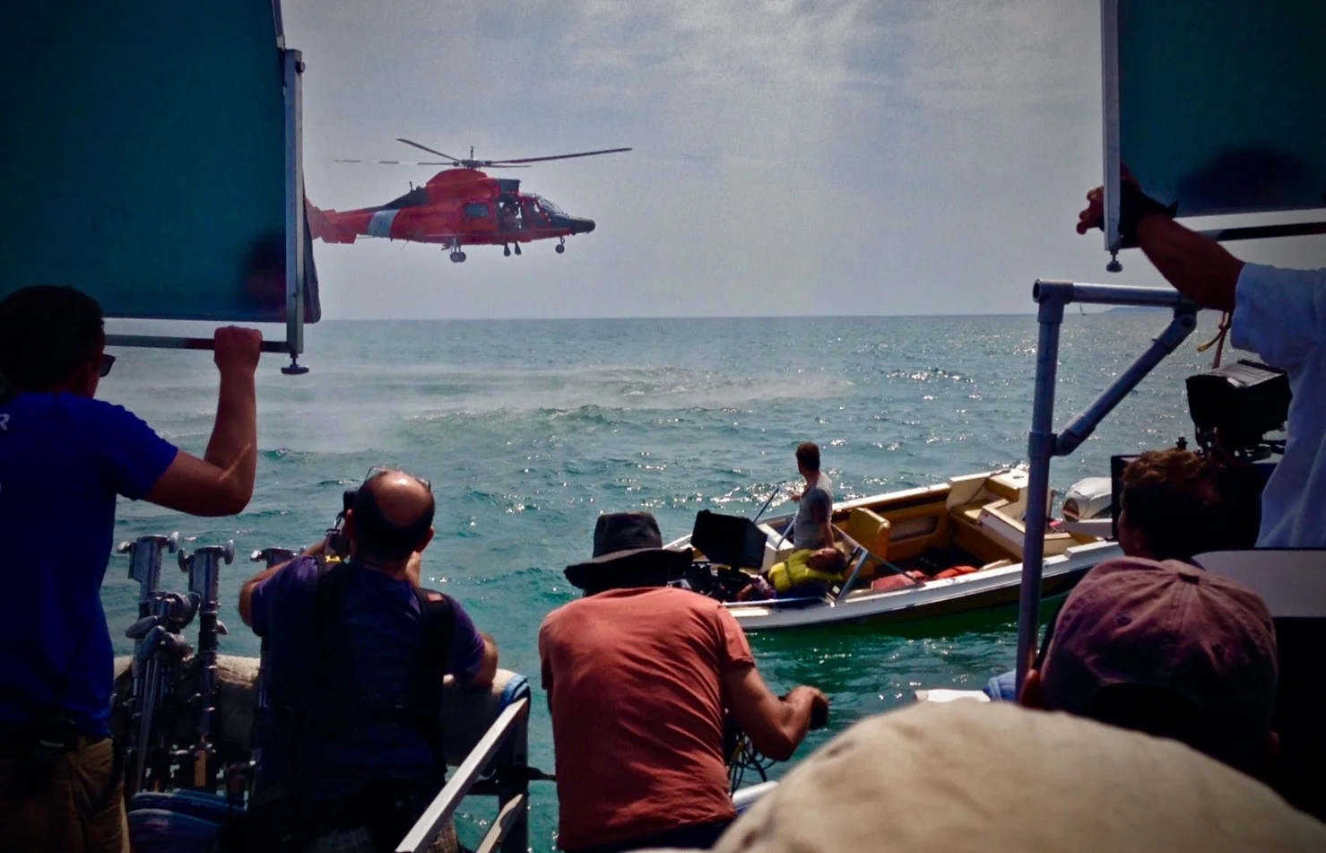 JIMMY SAMMARCO, (CENTER) ON CAMERA, FILMING A COAST GUARD RESCUE SCENE FOR “THE SURFACE”