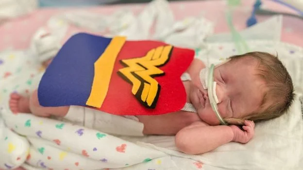One baby was dressed as Wonder Woman. Image copyright: FACES YOU LOVE PHOTOGRAPHY AND MARCH OF DIMES.