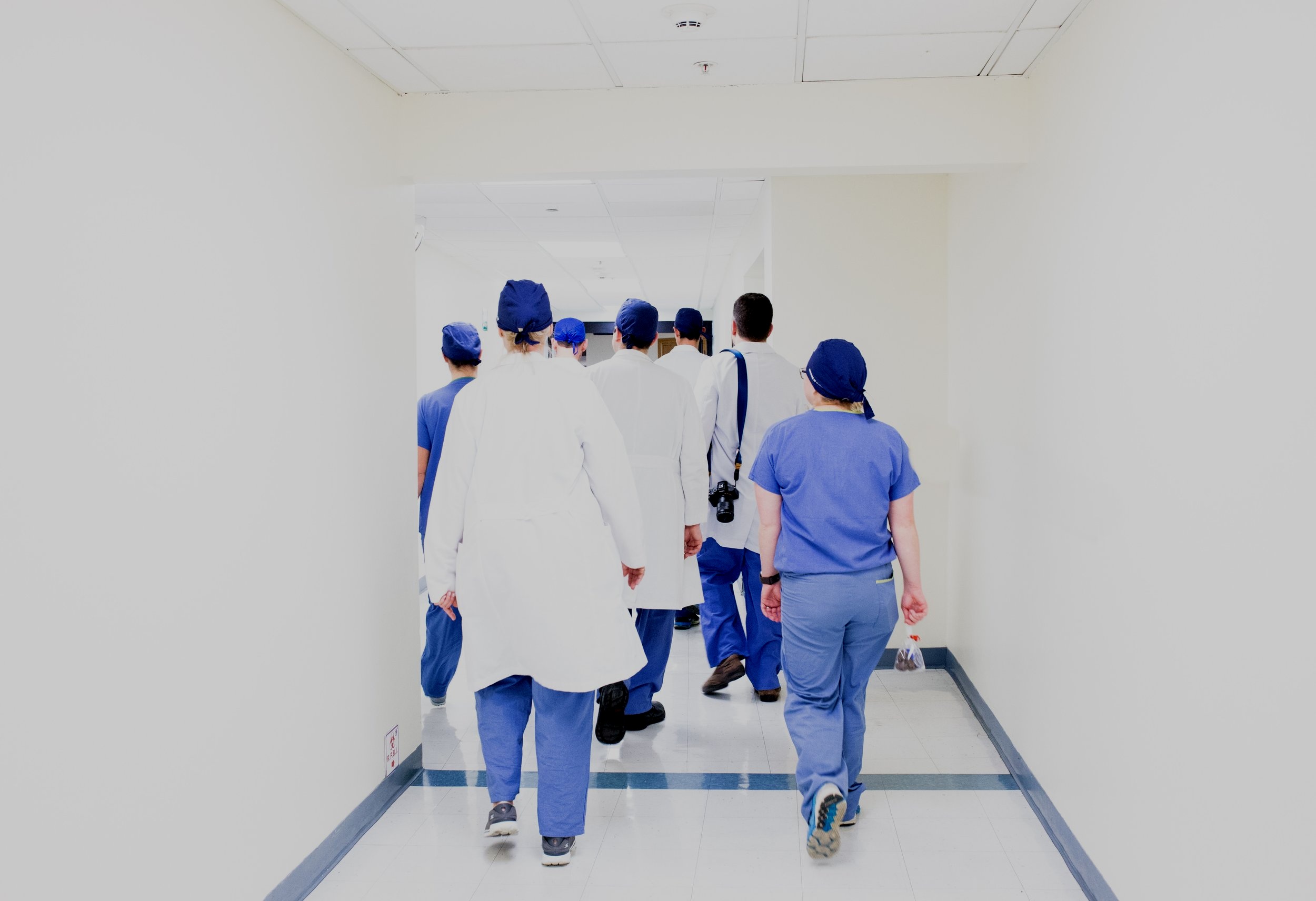 Doctors and nurses walking down a hallway