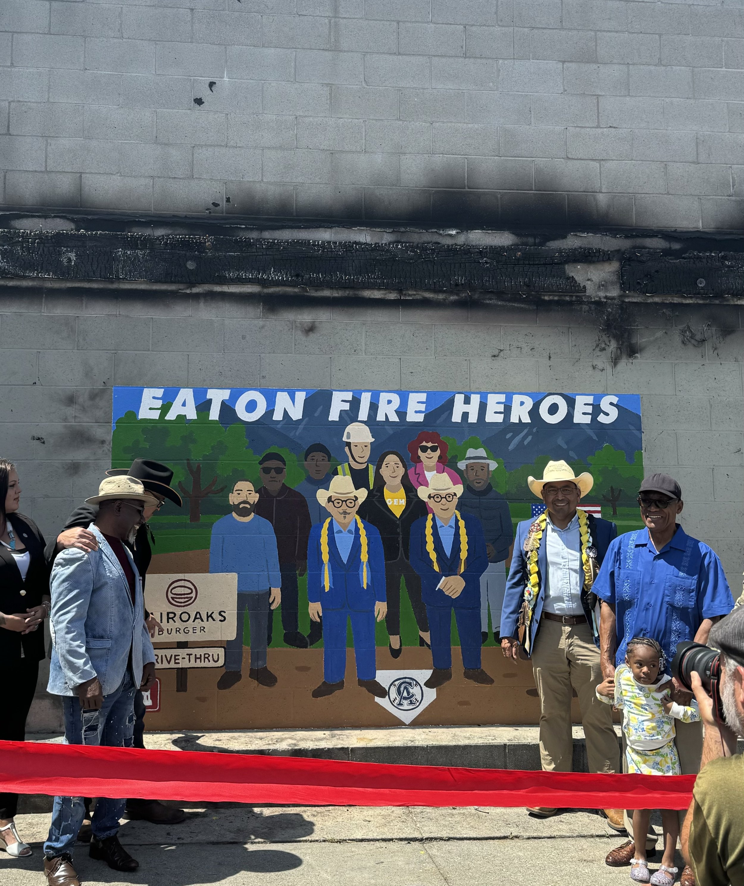 Intern Zackary Yen celebrating the unveiling of a mural dedicated to first responders of the Eaton Fire.