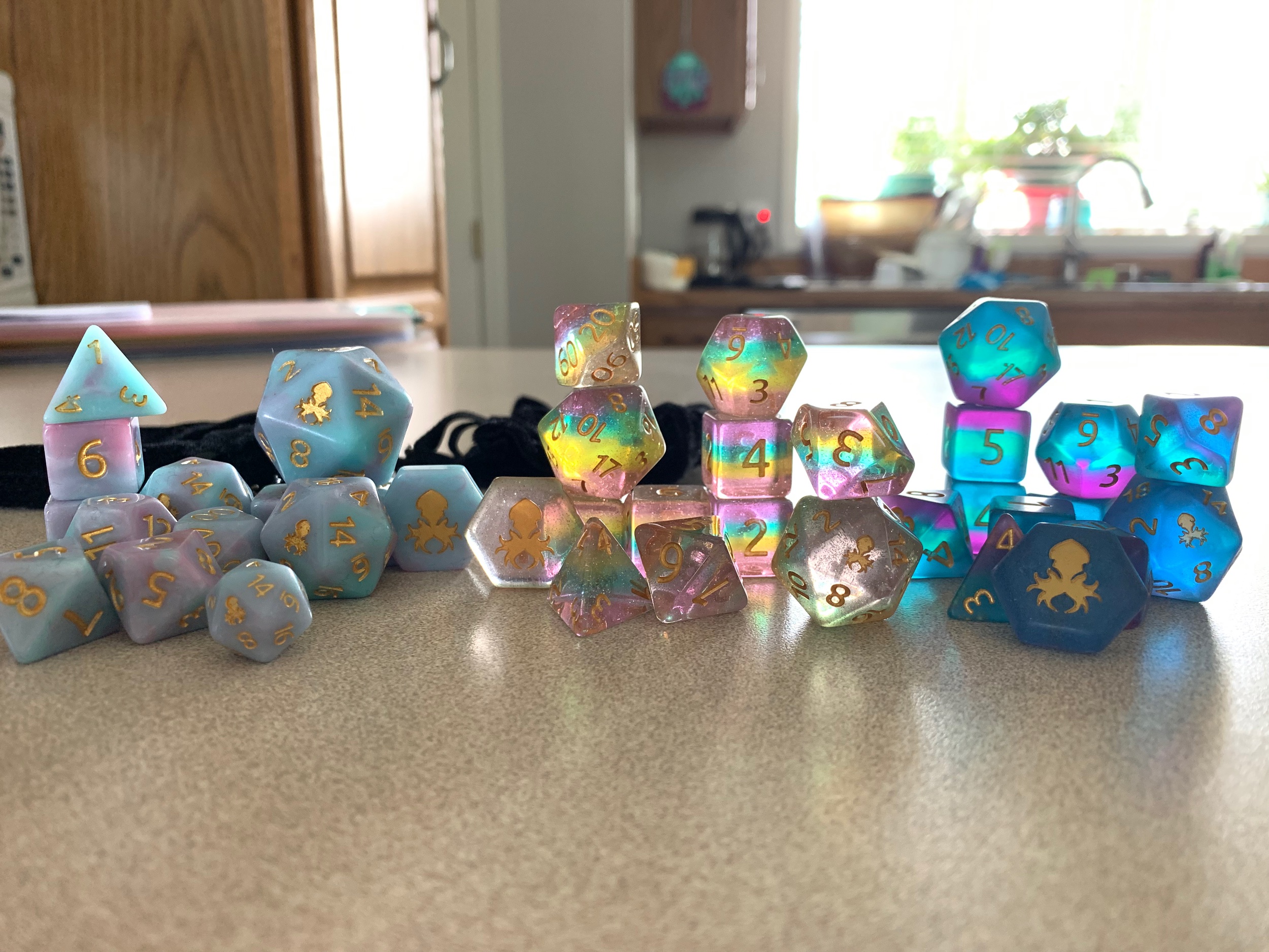L to R: Cotton Candy I (reissiue with giant D20, mini D20, and D2), Unicorn Tears, Tahiti Twilight Sea Glass (I call them Coulson lol)
