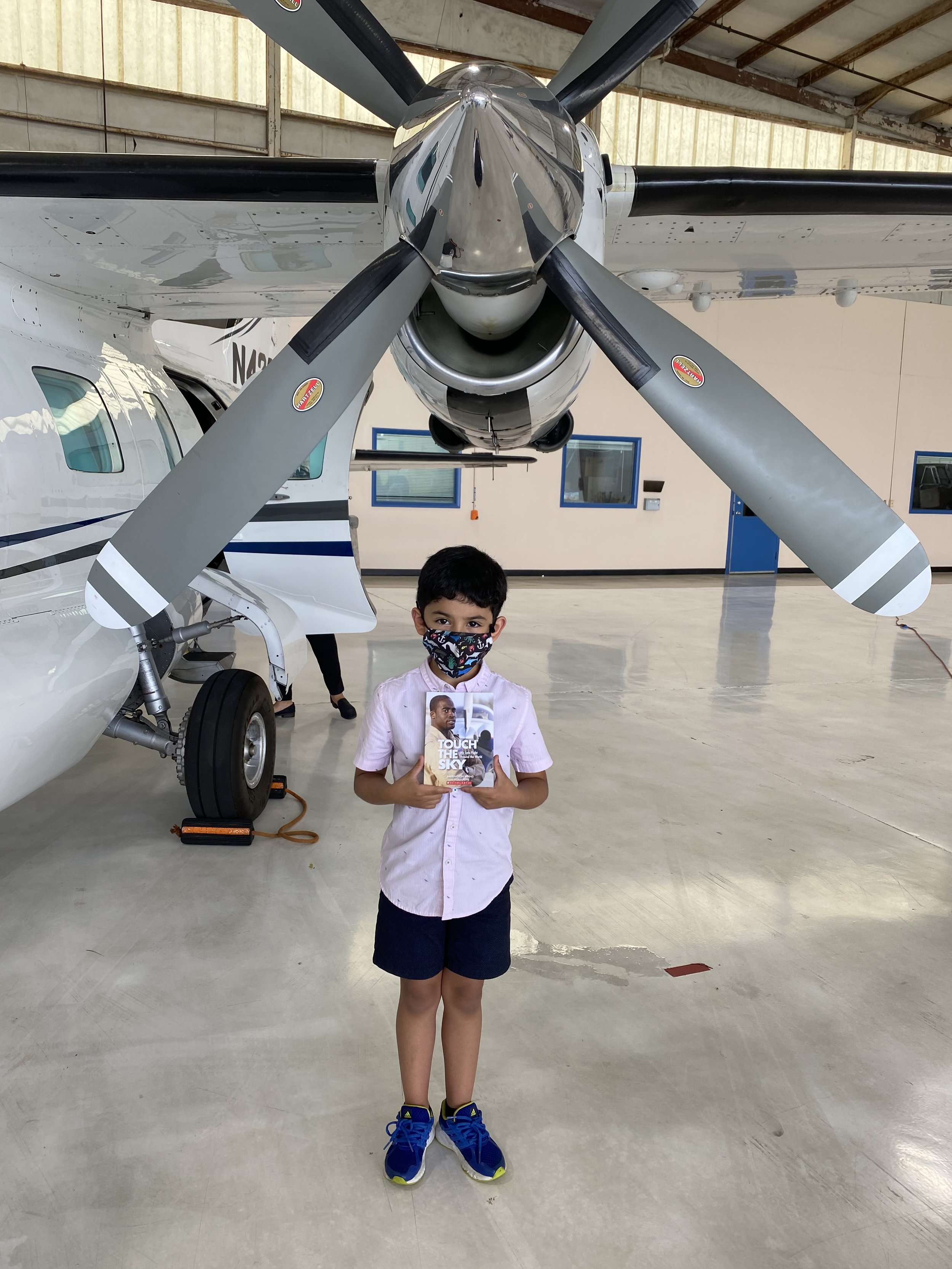 Student Diego with book under propeller.jpeg